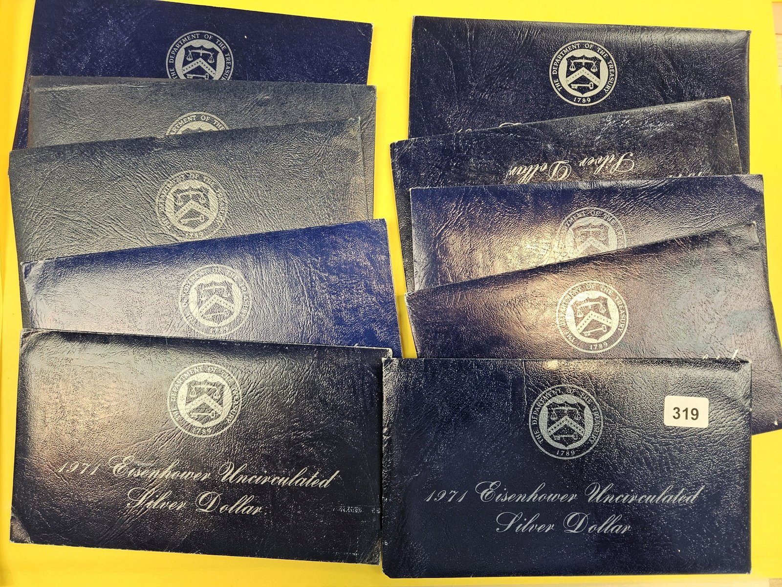Ten Uncirculated Eisenhower Silver Dollars: Blue Ikes. In OGP