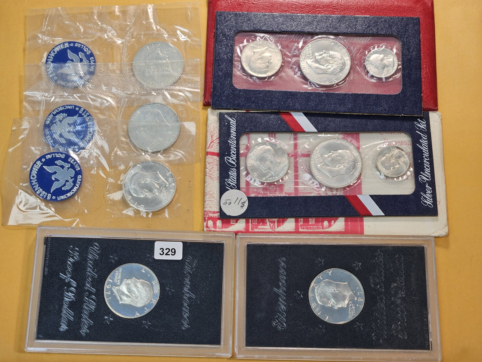 Seven US Mint Silver Items: Three Uncirculated Blister Pack and two GSA Hardcase Eisenhower Silver Dollars with two Silver 3-Coin Bicentennial Sets