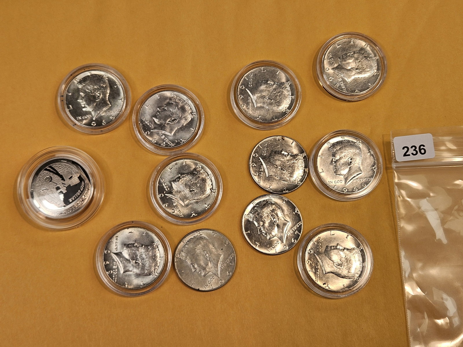Twelve mixed Half Dollars: One commemorative, ten 40% and one 90%