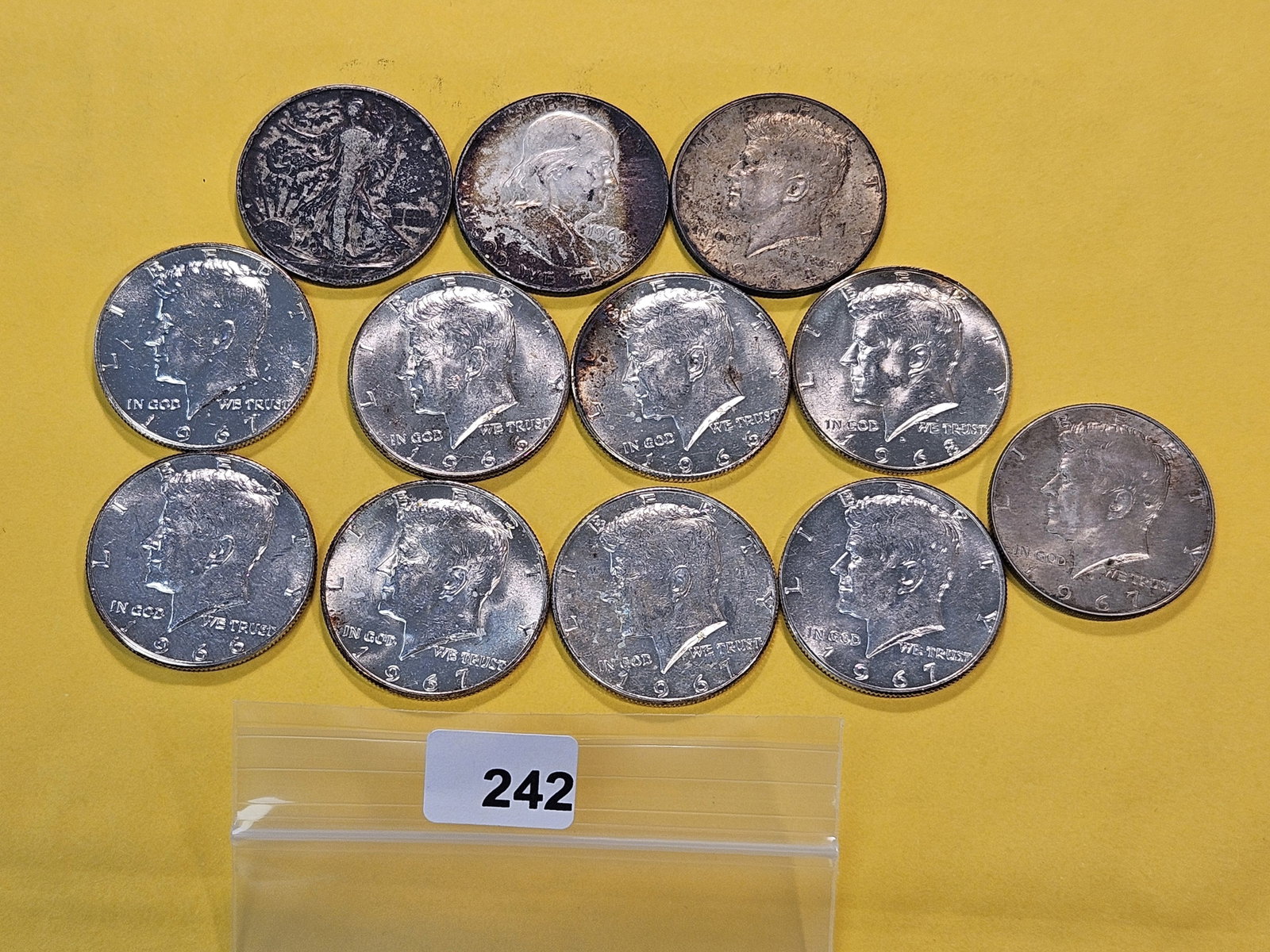 Three 90% Silver and Nine 40% Silver Half Dollars: 1942 Walking Liberty, 1960 Franklin and 1964 Kennedy Silver Half Dollars with nine 40% Kennedy's