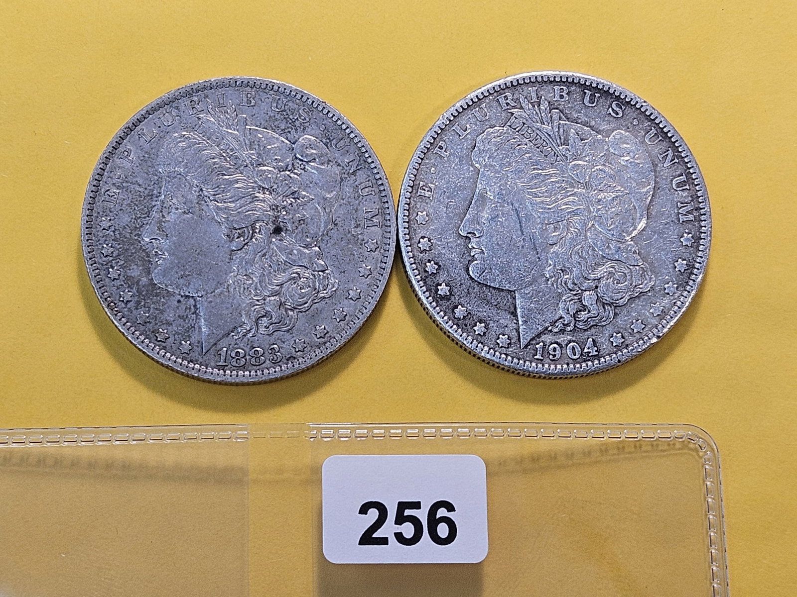 Two About Uncirculated Morgan Silver Dollars: 1883-O and 1904