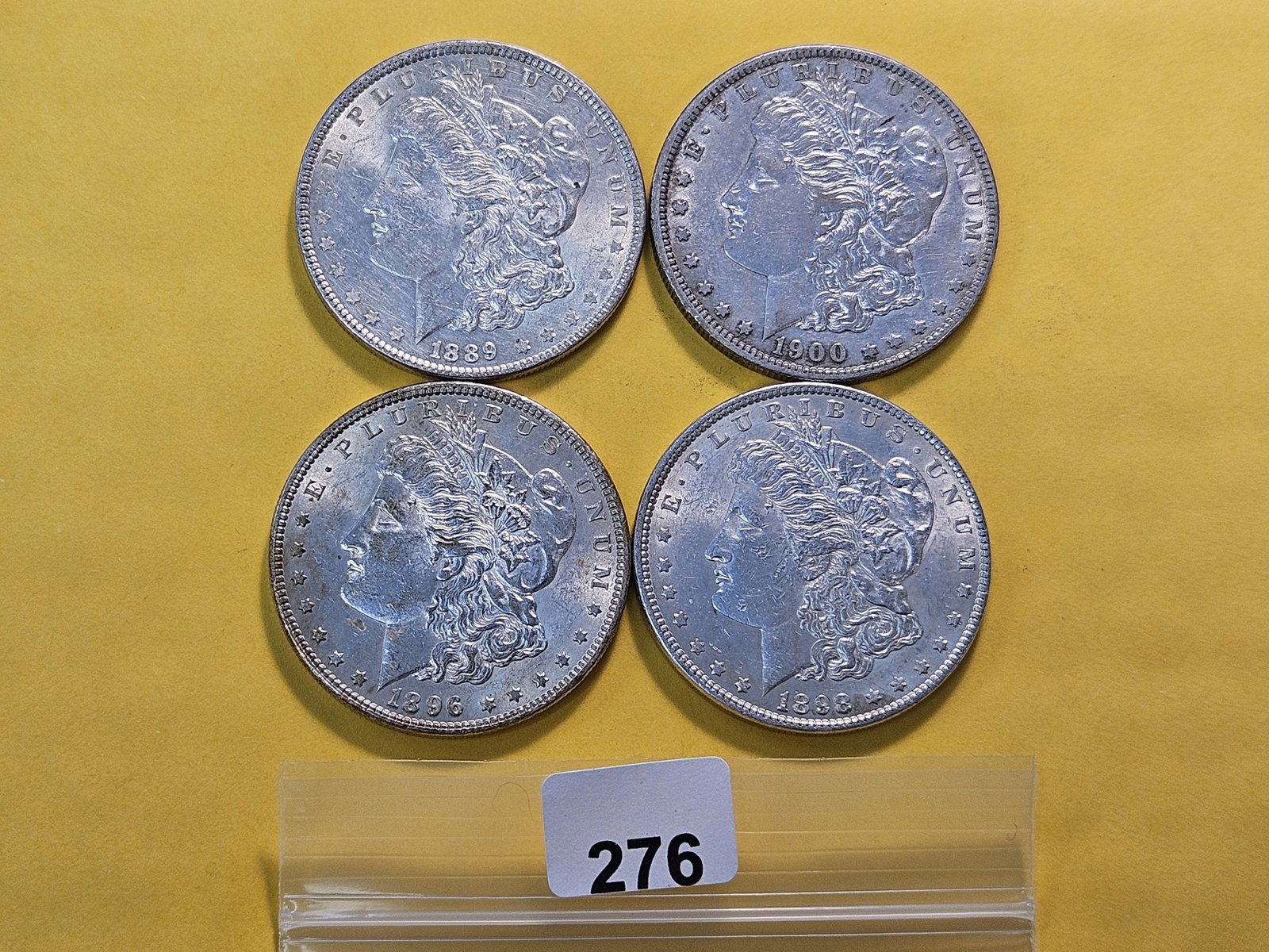 Four About Uncirculated Morgan Silver Dollars: 1896, 1898, 1889 and 1900-O