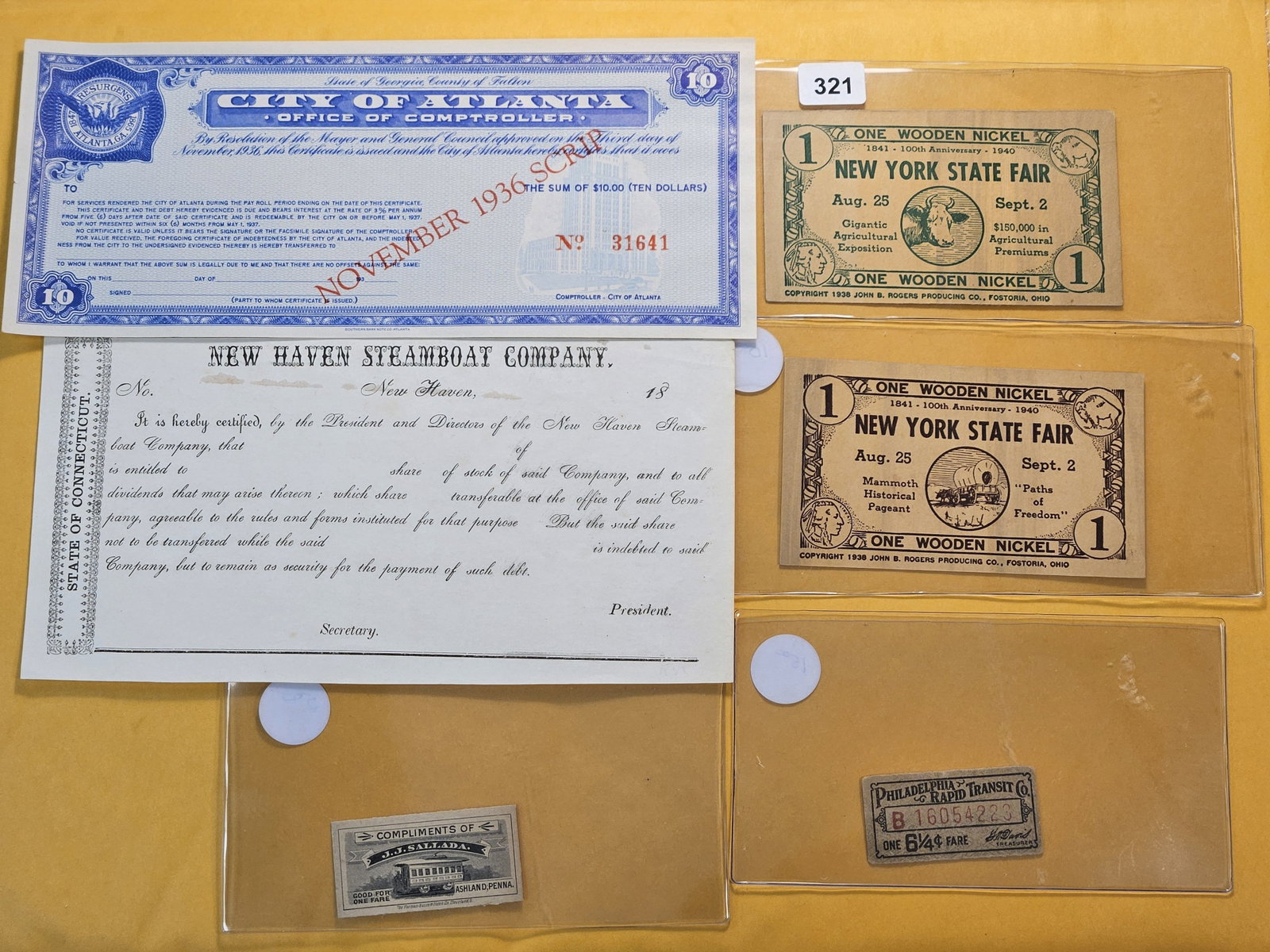 Six United States Paper Items: New Haven Steampoat Company Share, 1936 City of Atlanta Ten Dollar Scrip, Two New York State Fair "Wooden" Nickels, and two Train Tickets
