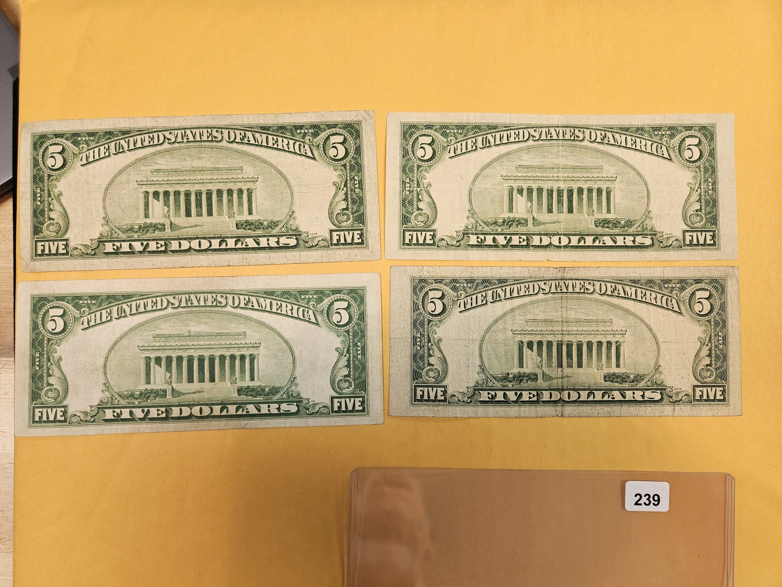 Four mixed $5 US pieces of currency - 2