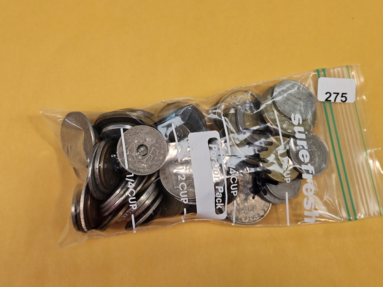 One and one-quarter mixed World Coins: From dealer. Unchecked by us.