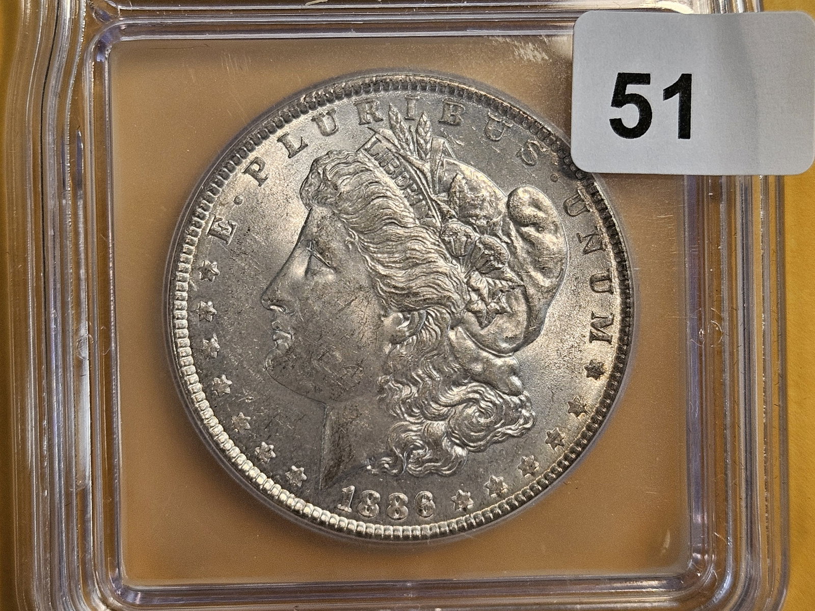 ICG 1886 Morgan Dollar in Mint State 62: Good luster