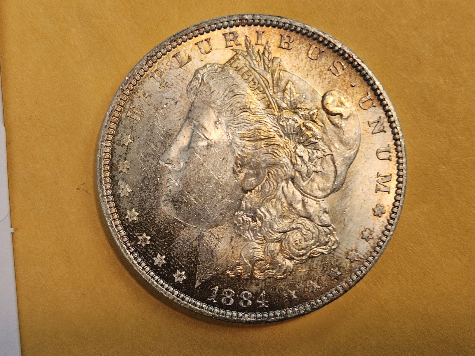 Choice Brilliant Uncirculated plus 1884-O Morgan Dollar: Beautiful obverse toning