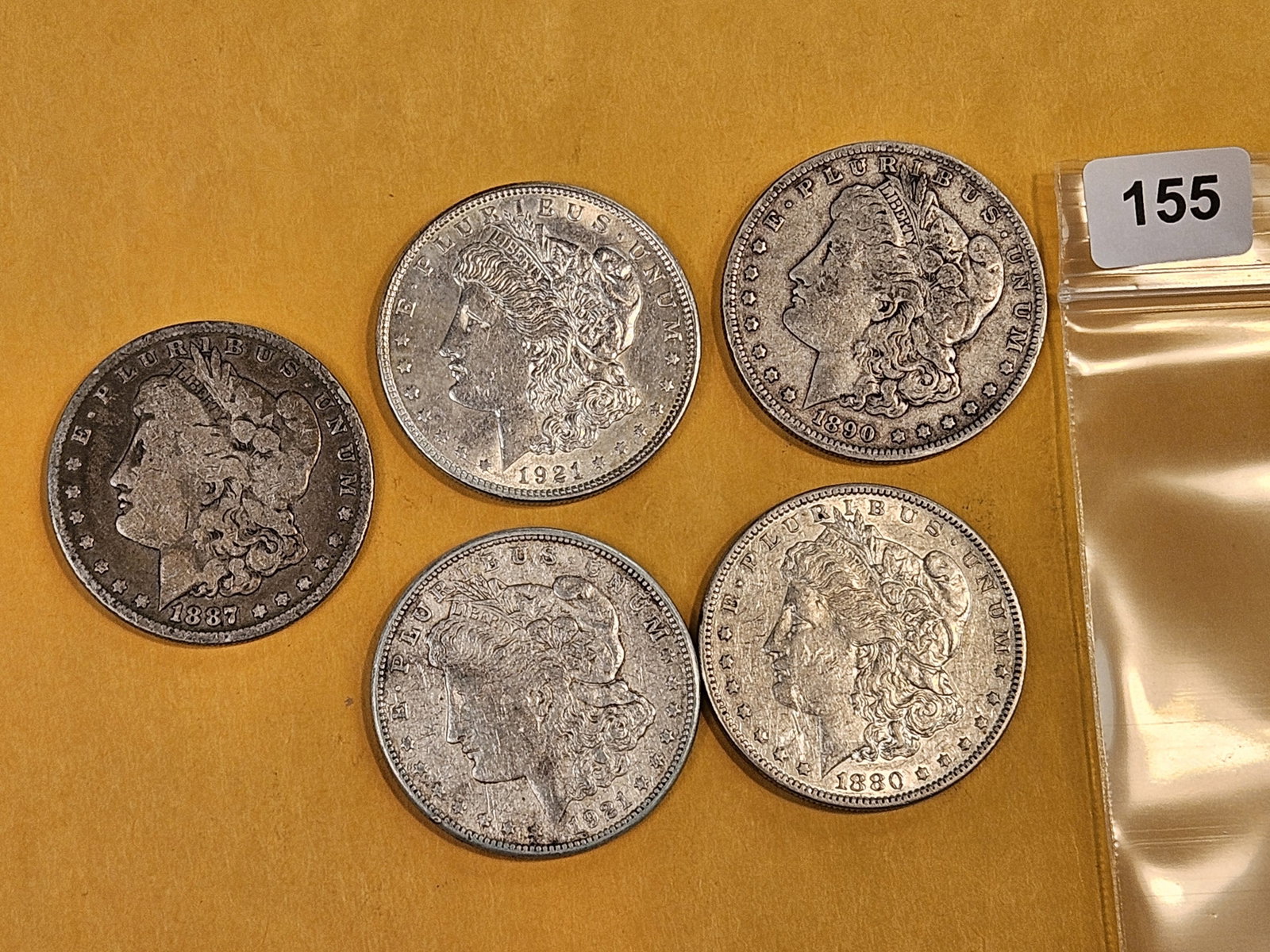 Five Morgan Silver Dollars: Mixed dates and grades