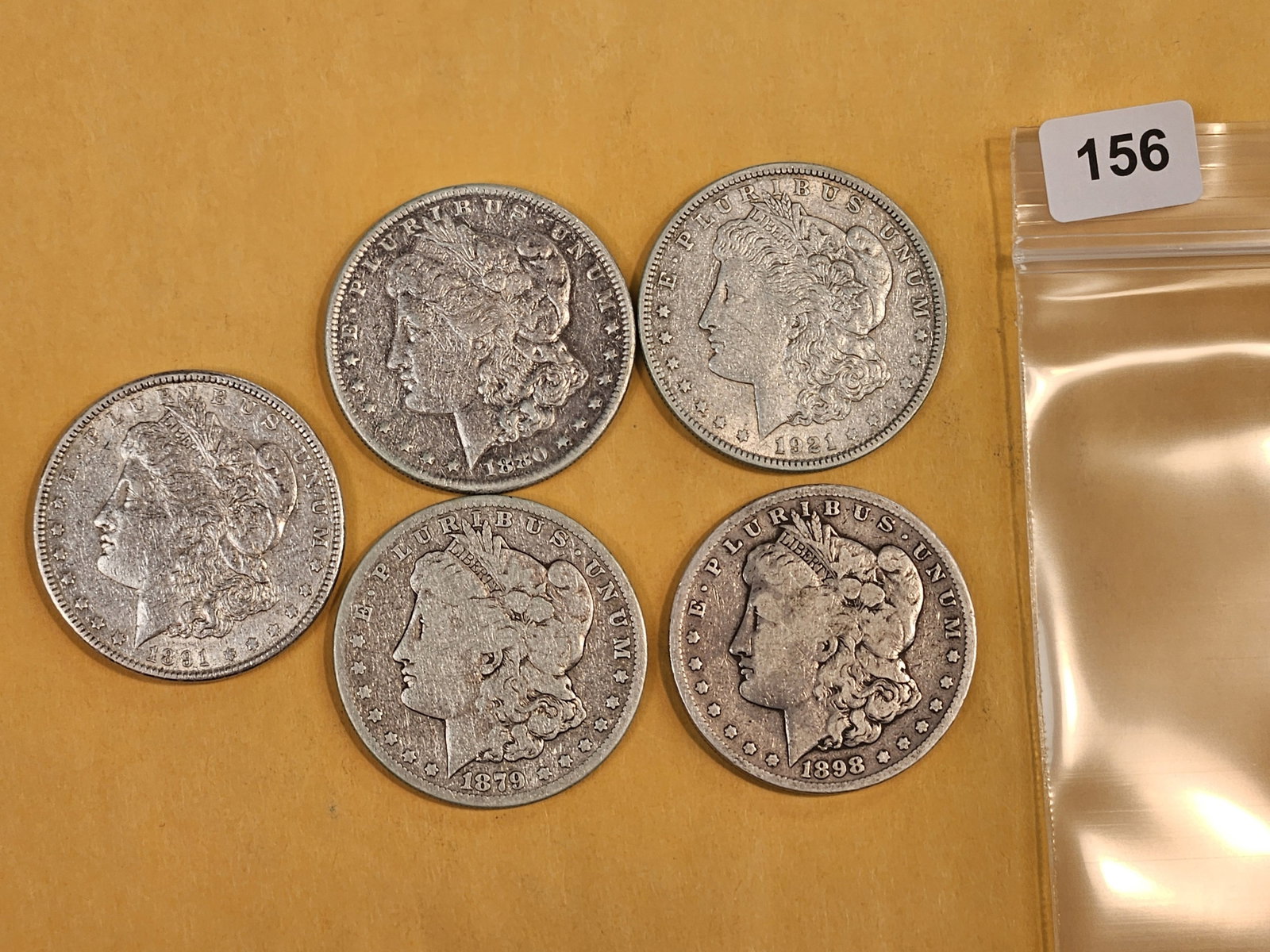 Five Morgan Silver Dollars: Mixed dates and grades