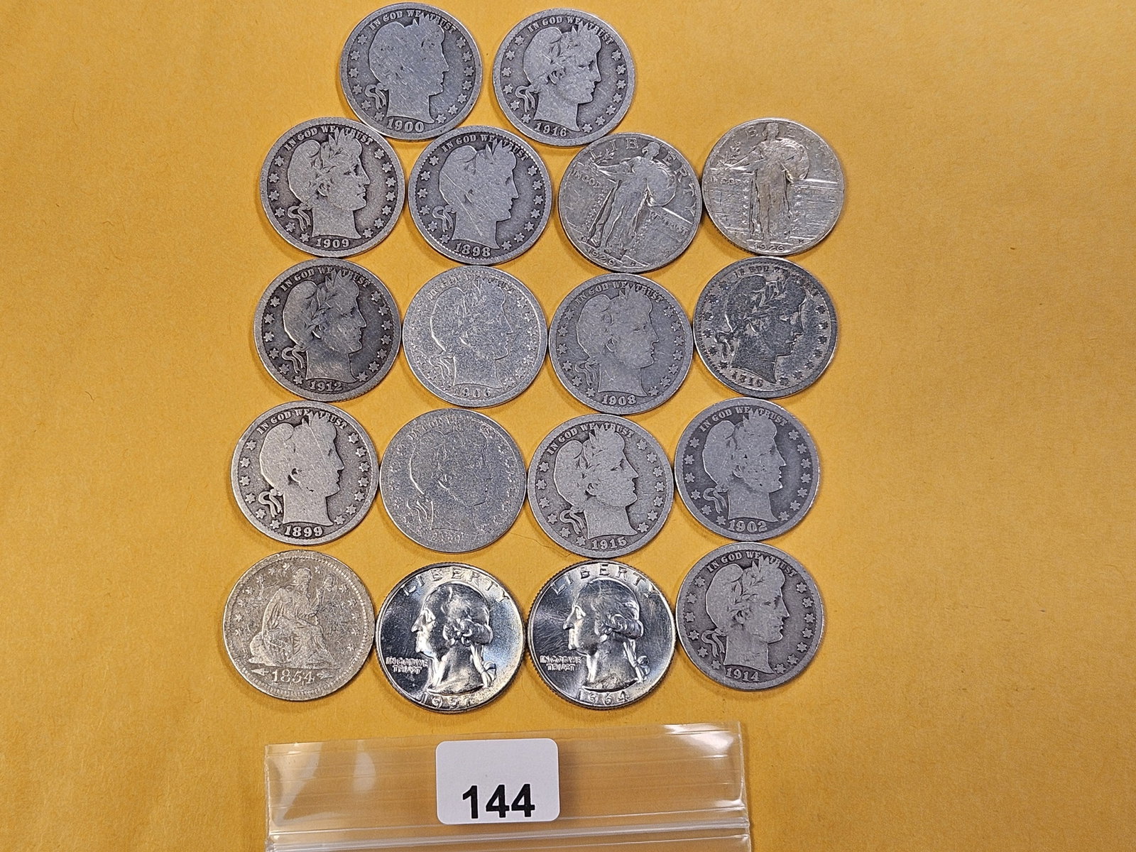 Eighteen Mixed US Silver Quarters: 1854 Seated Liberty Silver Quarter, two Standing Liberty Silver Quarters, two Washington Quarters and thirteen Barber Silver Quarters
