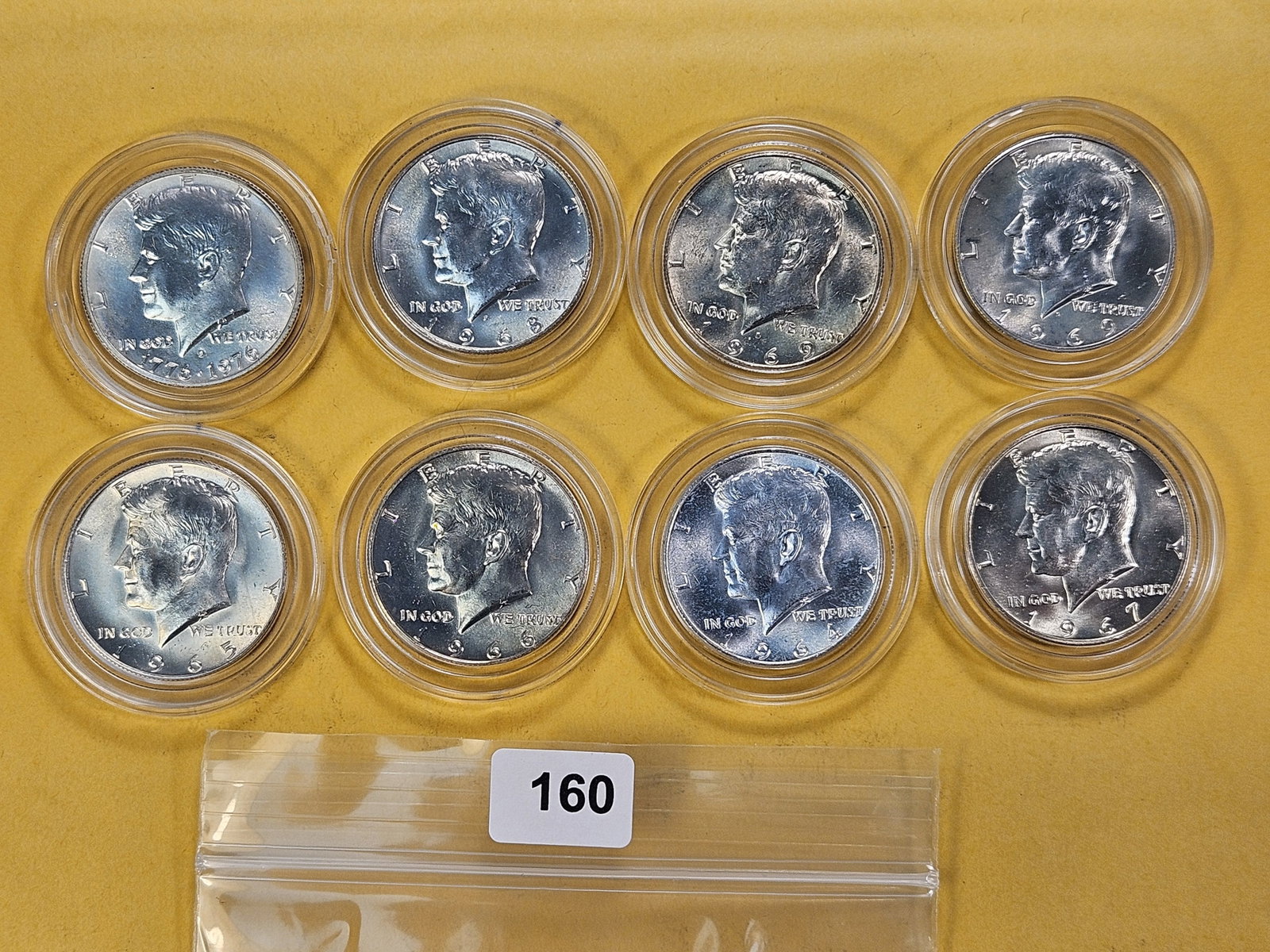 Eight Kennedy Silver Half Dollars: One 1964 and seven 40% Silver Half Dollars, mixed dates