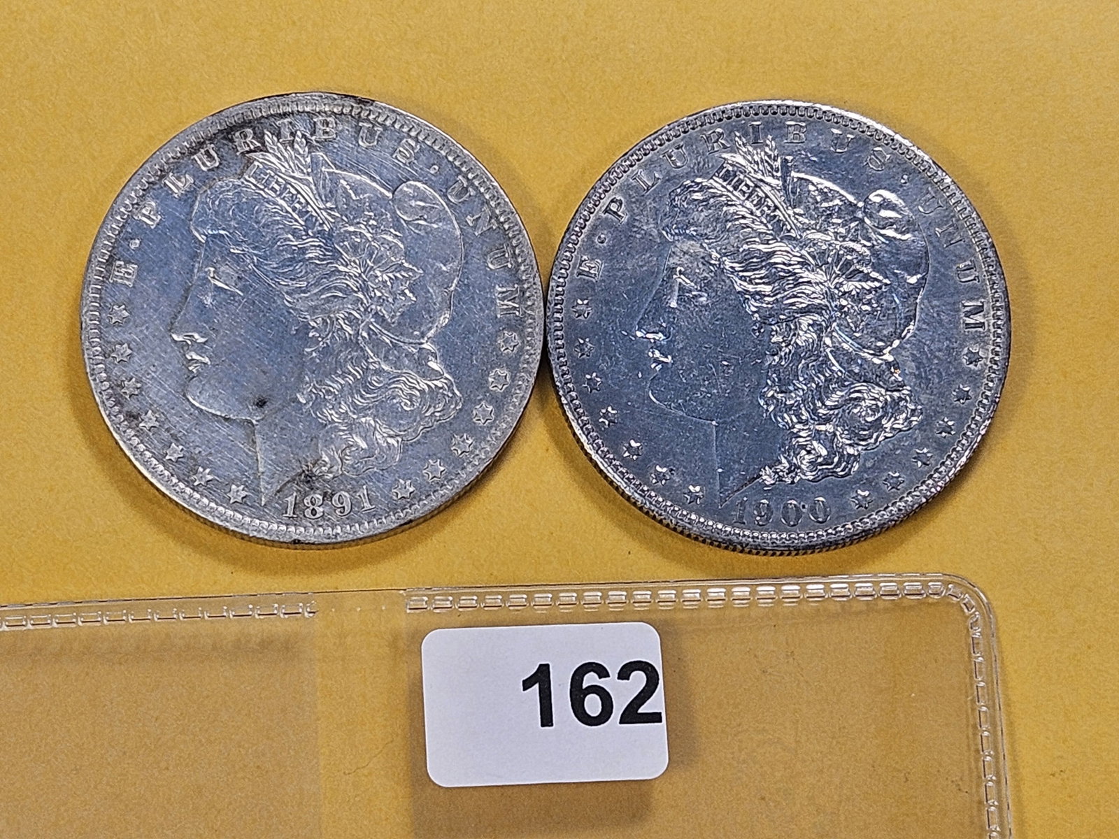Two About Uncirculated Morgan Silver Dollars: 1891-O and 1900