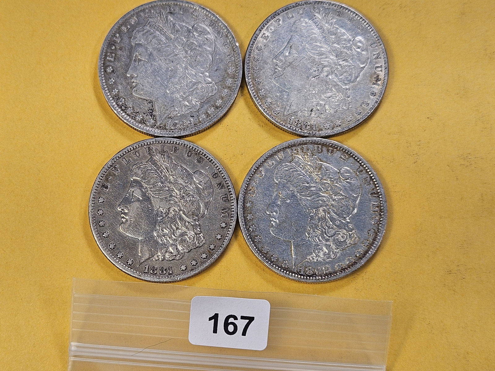 Four Morgan Silver Dollars: 1881, 1881-S, 1889-O and 1892