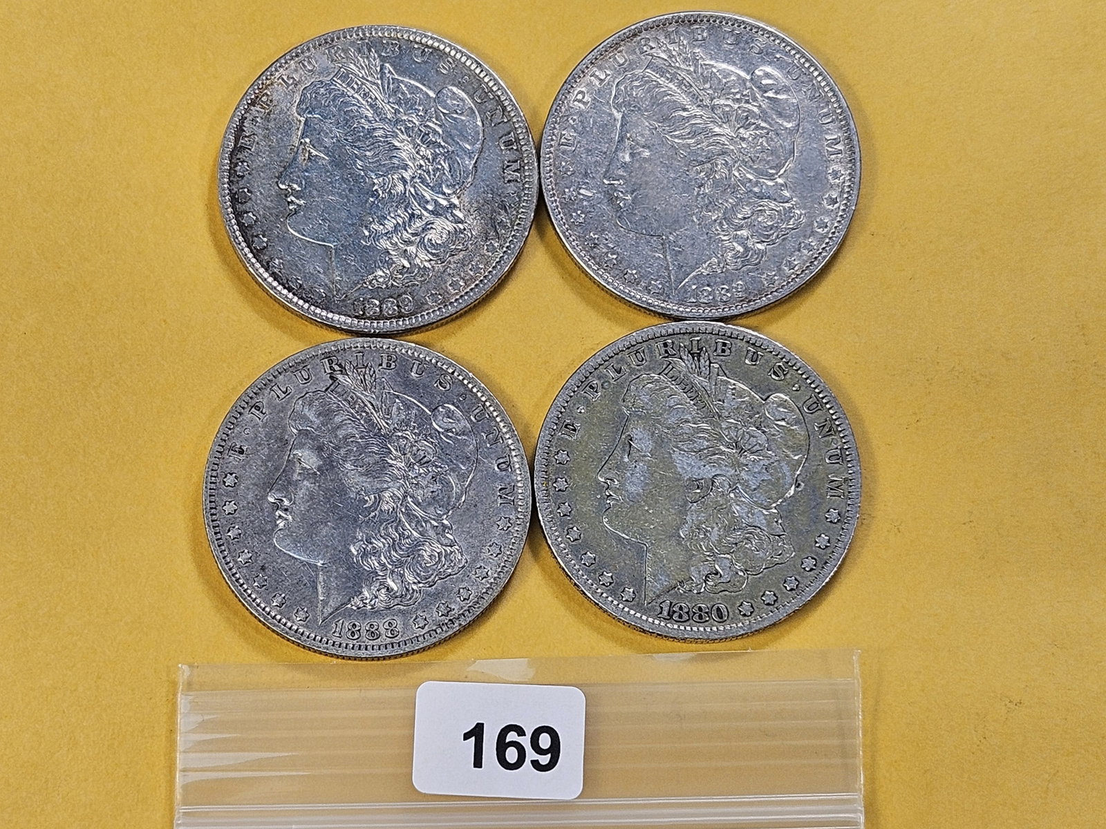 Four Morgan Silver Dollars: 1880, 1888-O and two 1889