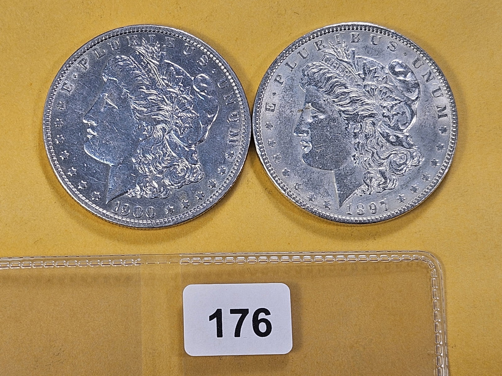 Two About Uncirculated Morgan Silver Dollars: 1897 and 1900-O