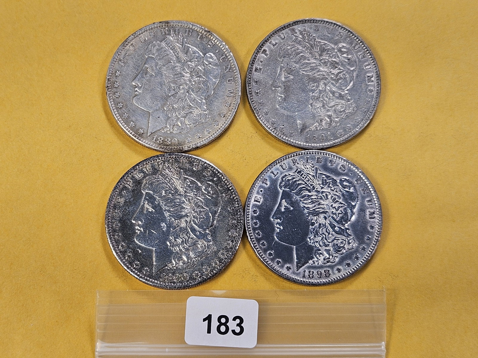 Four Morgan Silver Dollars: 1889, 1890-S, 1891 and 1898
