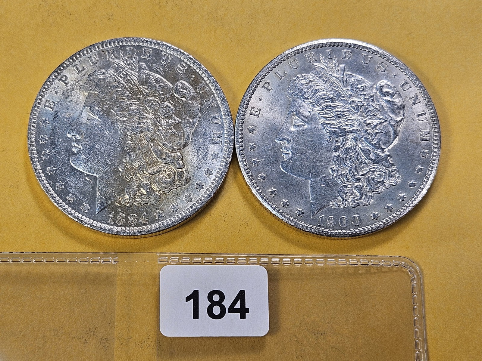 Two About Uncirculated Morgan Silver Dollars: 1884 and 1900