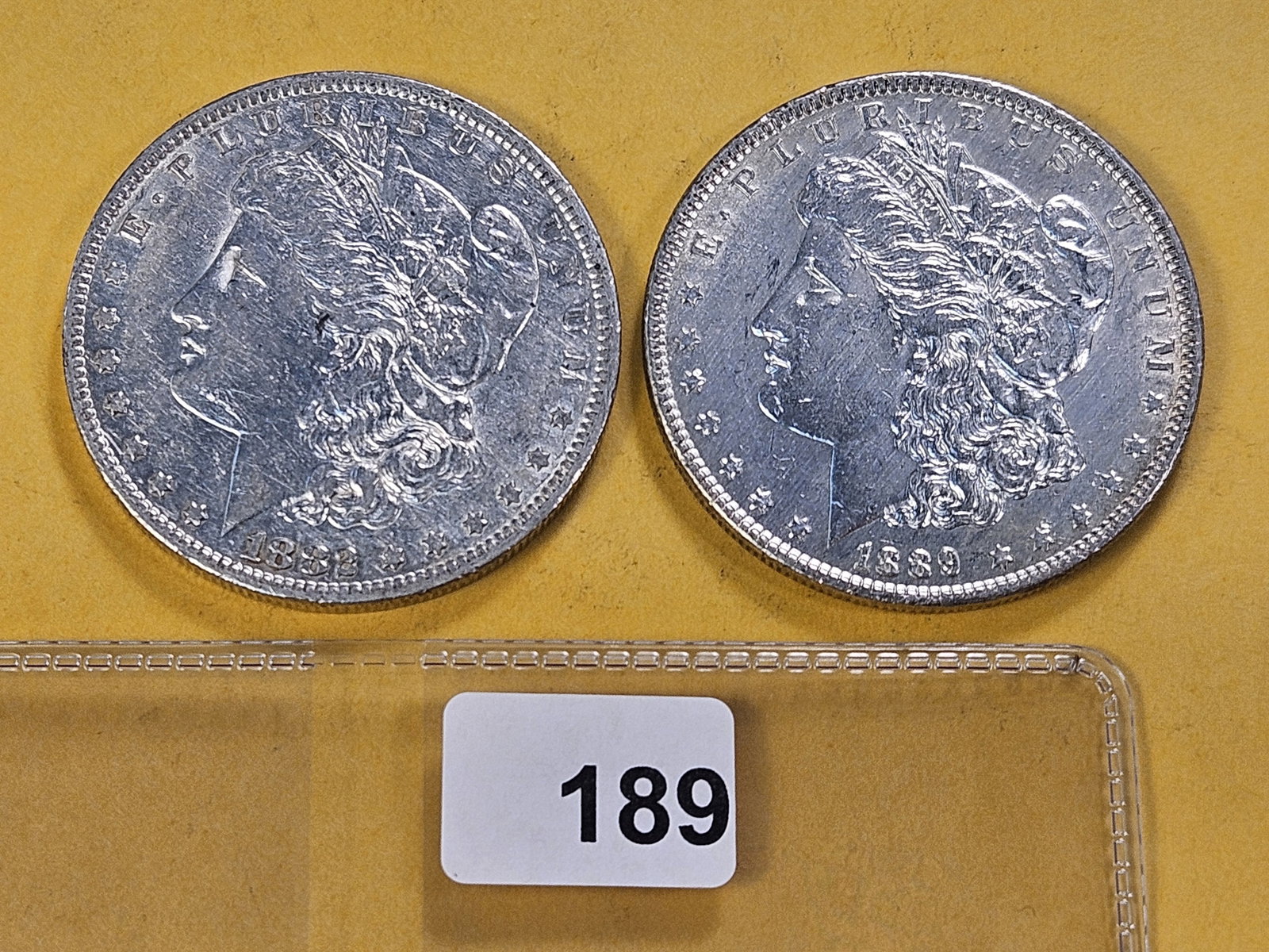 Two About Uncirculated Morgan Silver Dollars: 1882-O and 1889