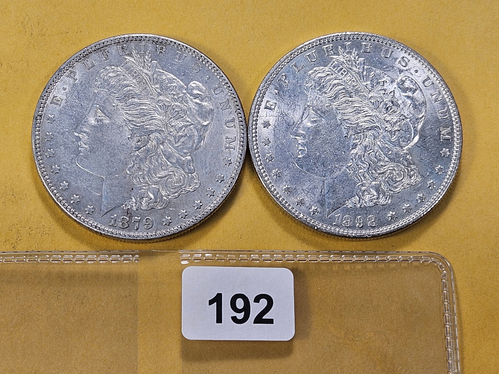 Two About Uncirculated Morgan Silver Dollars: 1879 and 1898