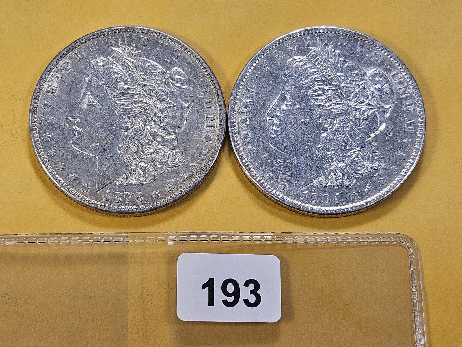 Two About Uncirculated Morgan Silver Dollars: 1878-S and 1904