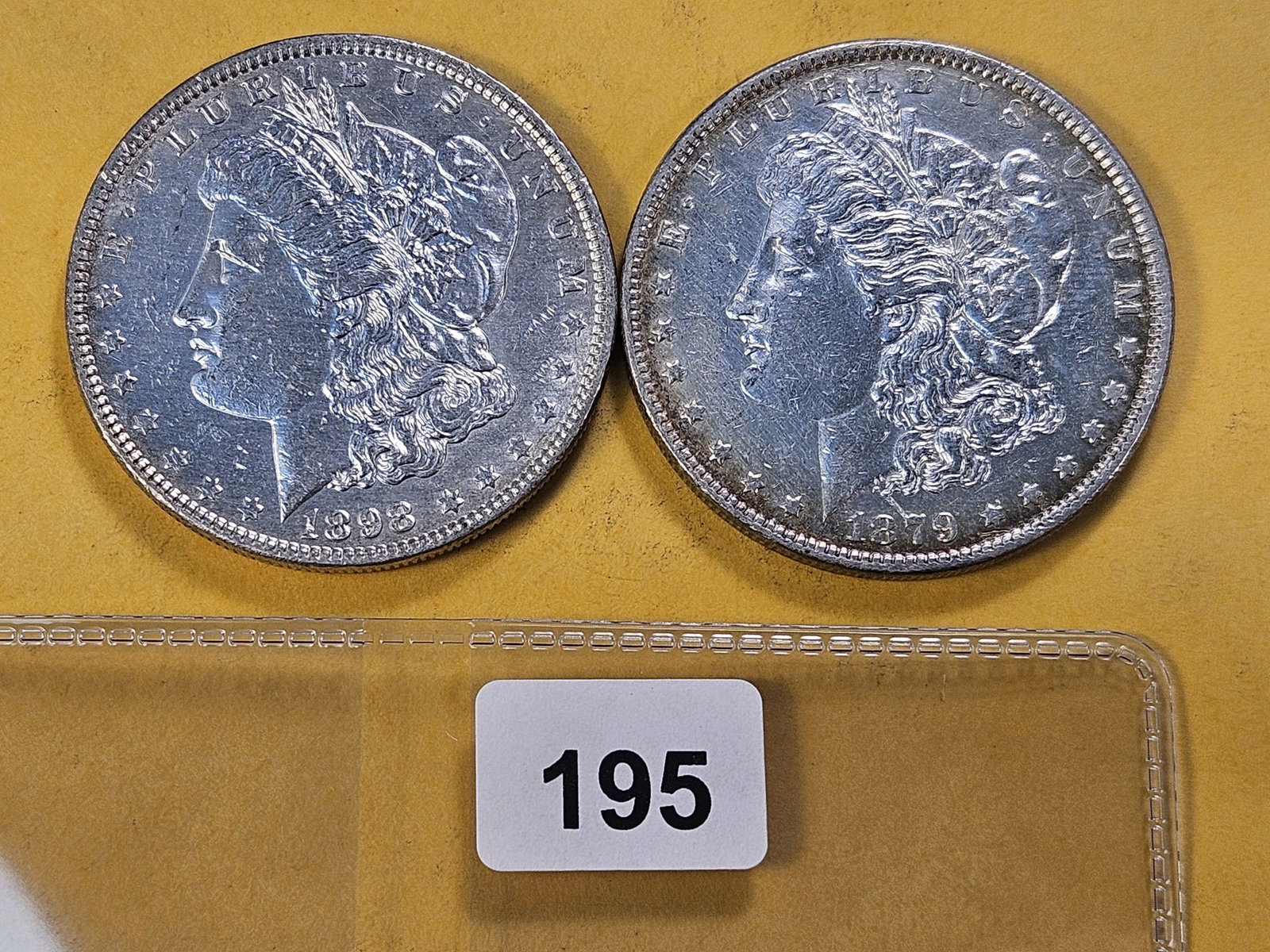 Two About Uncirculated Morgan Silver Dollars: 1879 and 1898