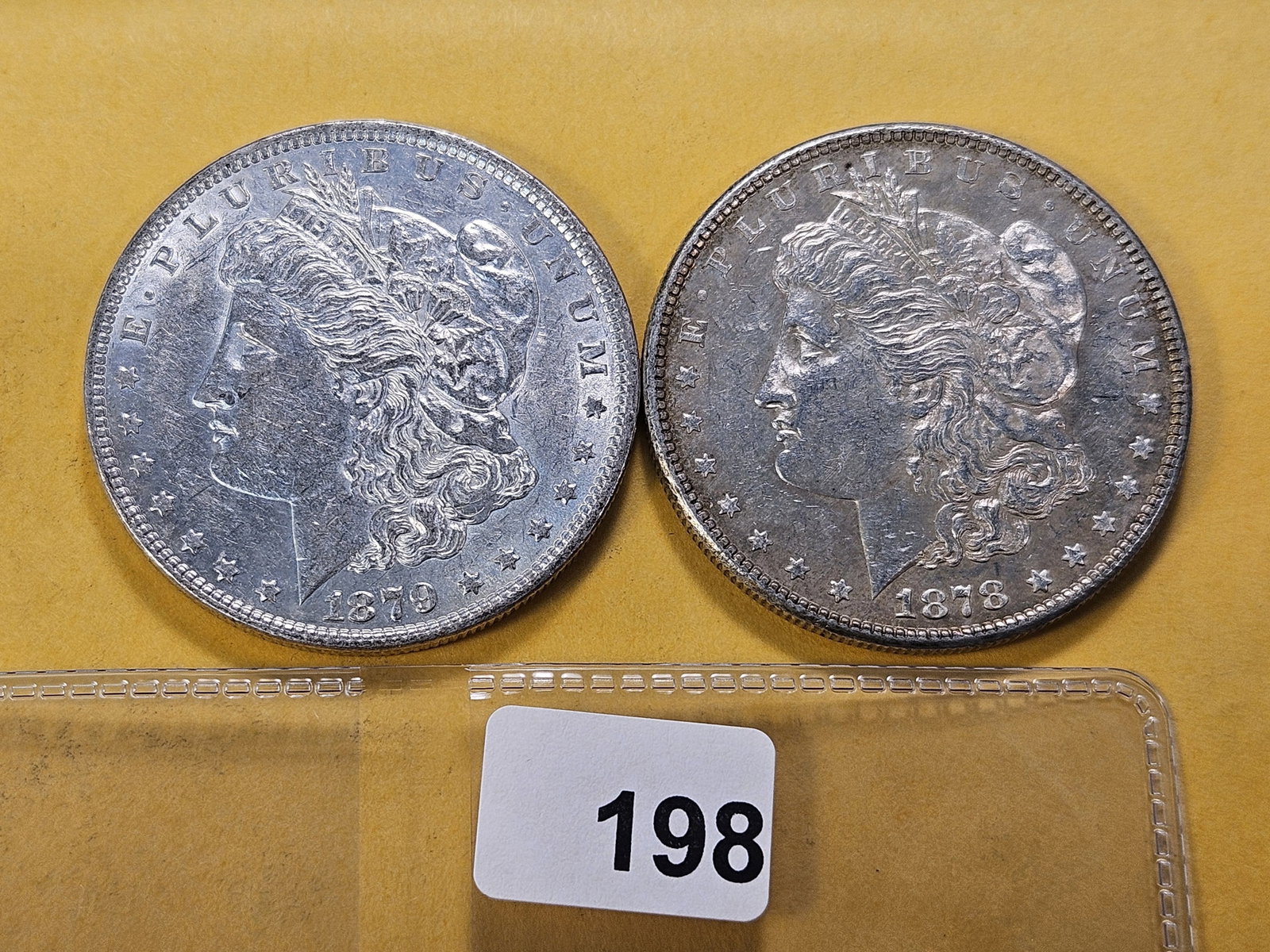 Two About Uncirculated Morgan Silver Dollars: 1878-S and 1879