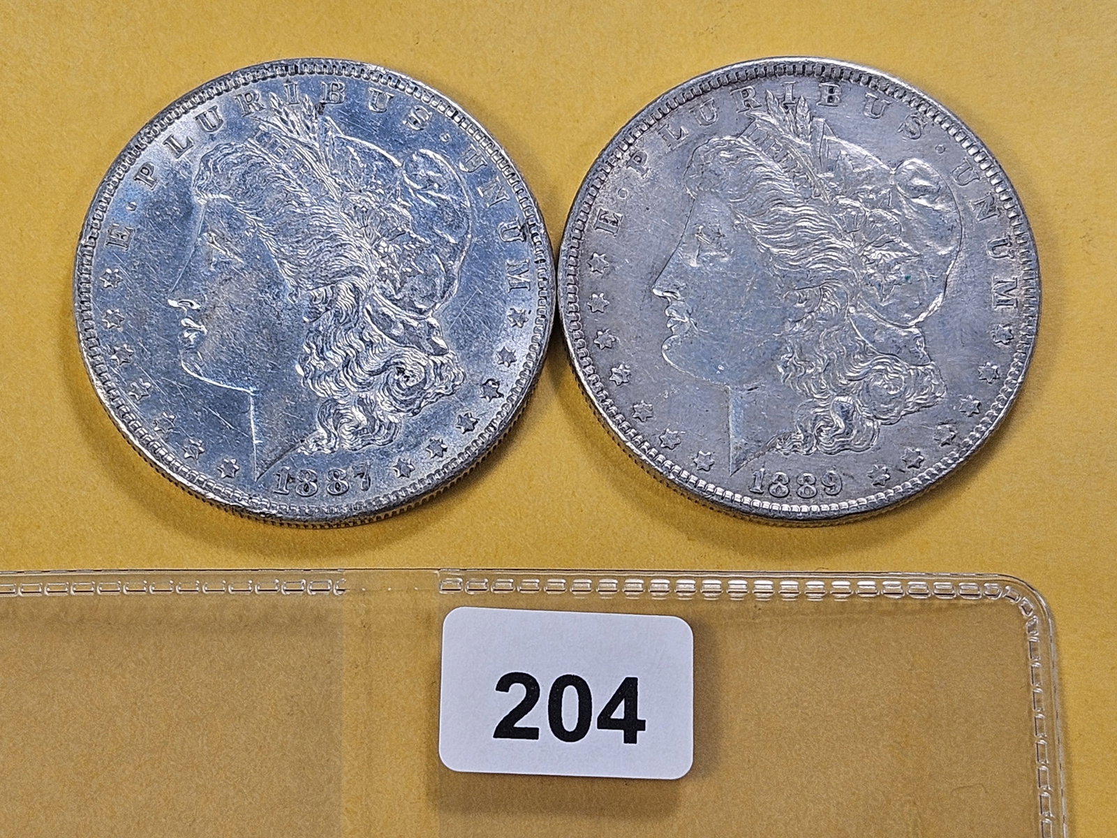 Two About Uncirculated Morgan Silver Dollars (1 of 4)