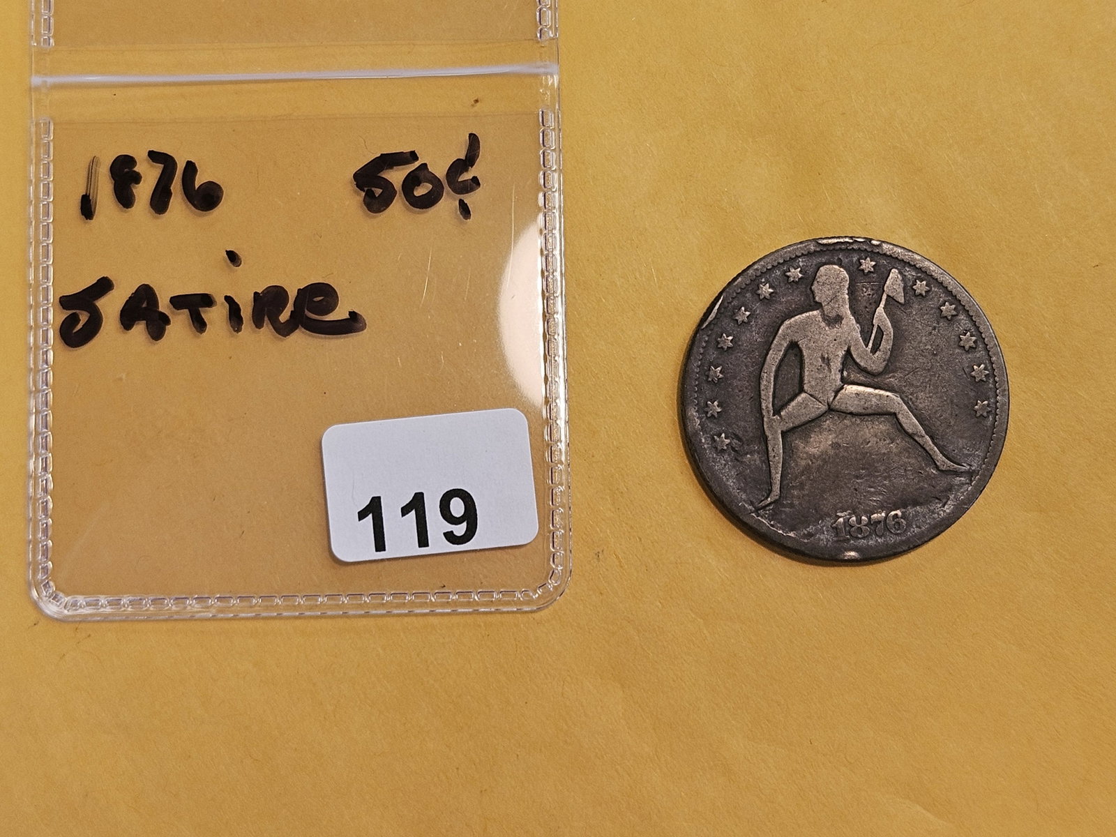 1876 Seated Liberty half Dollar: Umm….dealer wrote "satire" on the flip….hand-carved