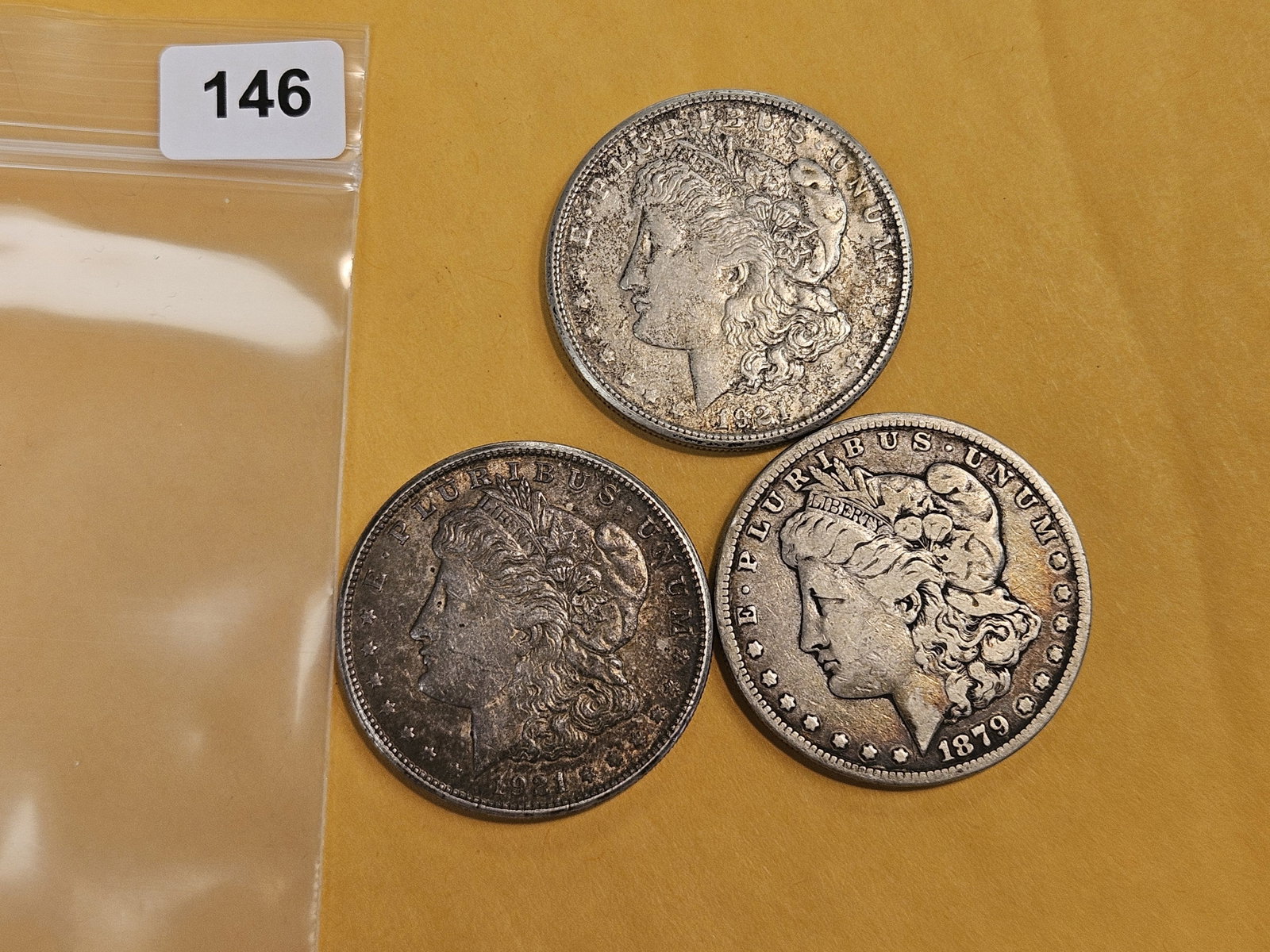 Three Morgan Silver Dollars: Mixed.