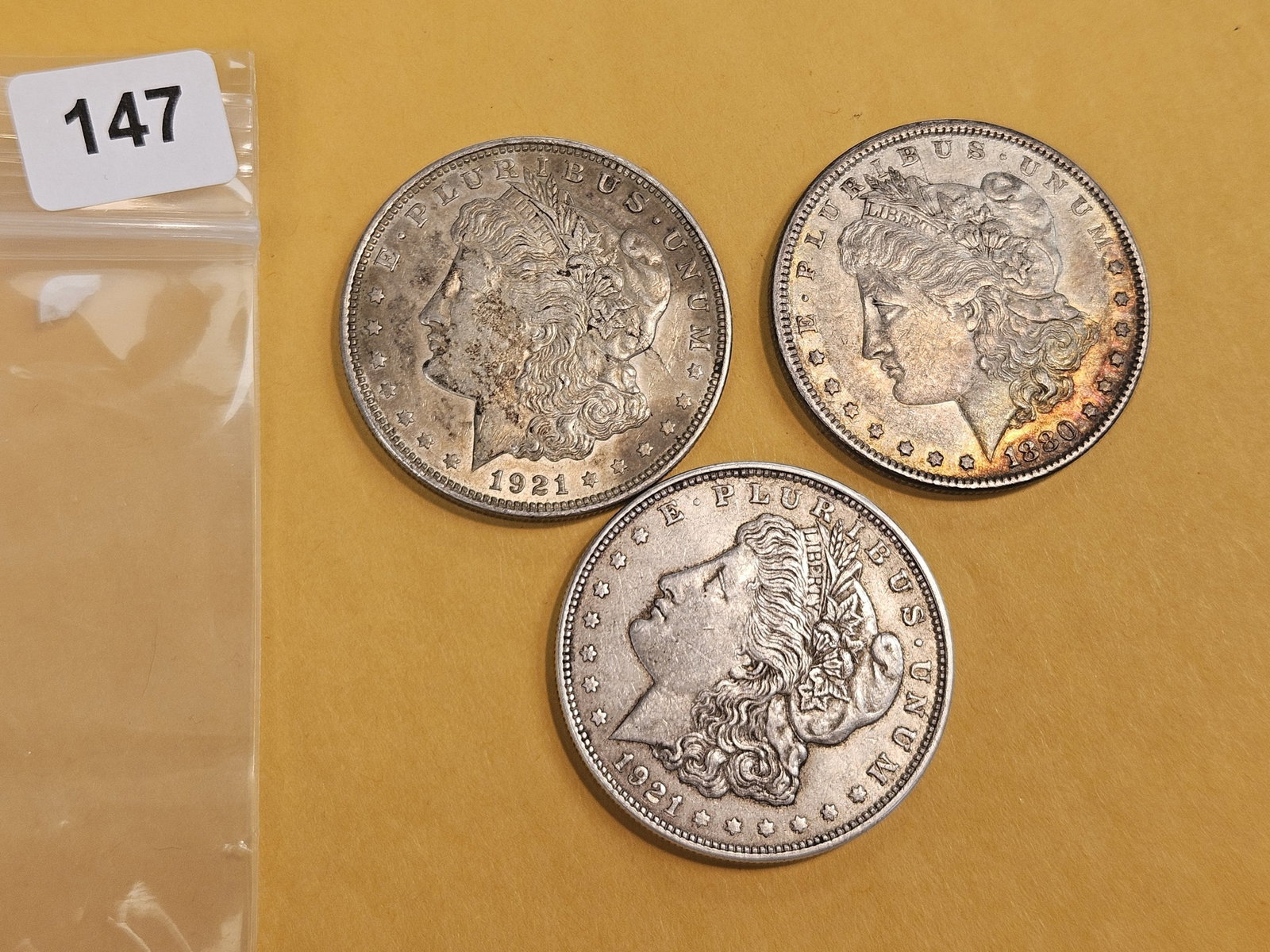 Three Morgan Silver Dollars: Mixed.