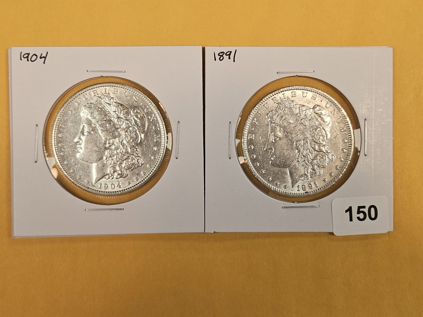 Two About Uncirculated Morgan silver Dollars: Mixed.