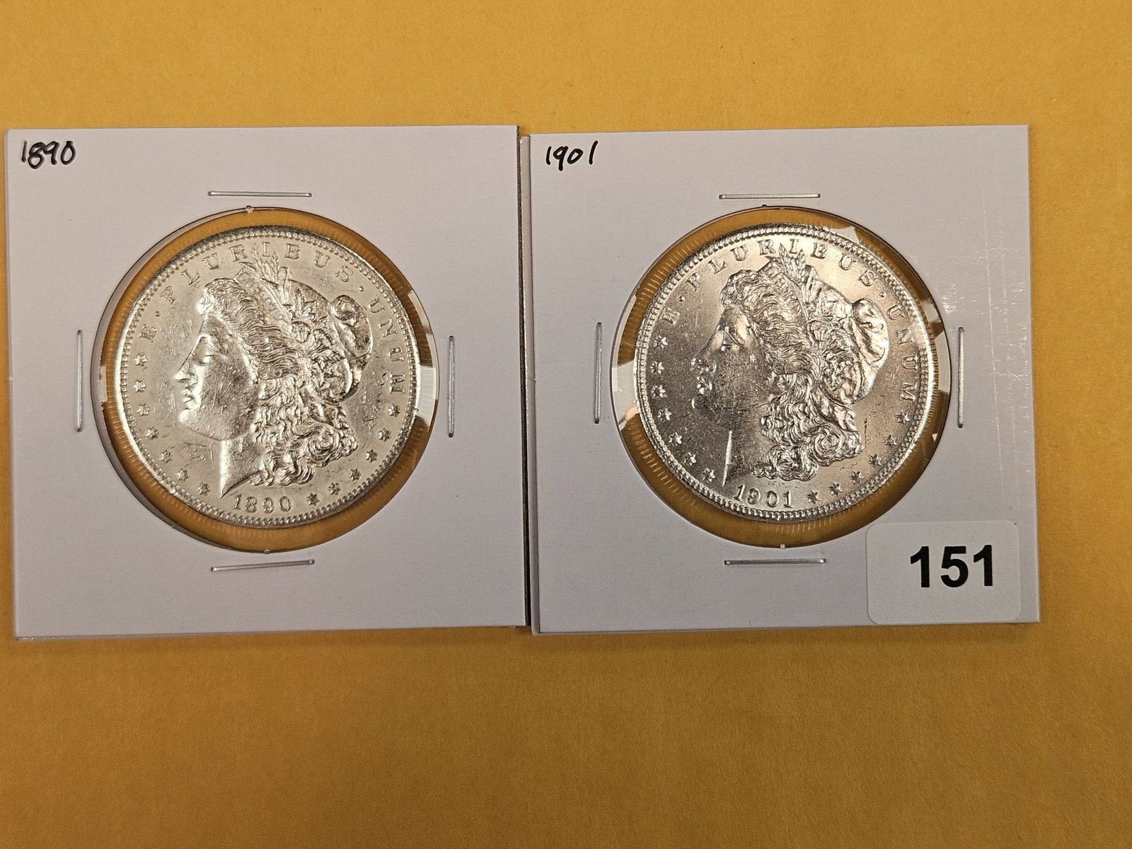Two About Uncirculated Morgan silver Dollars: Mixed.