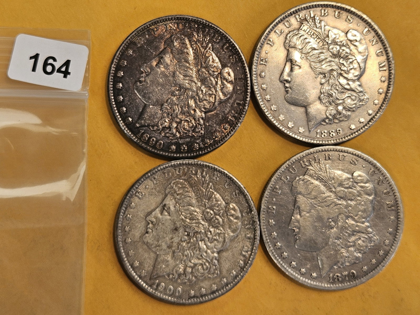 Four mixed Morgan Silver Dollars: Circulated