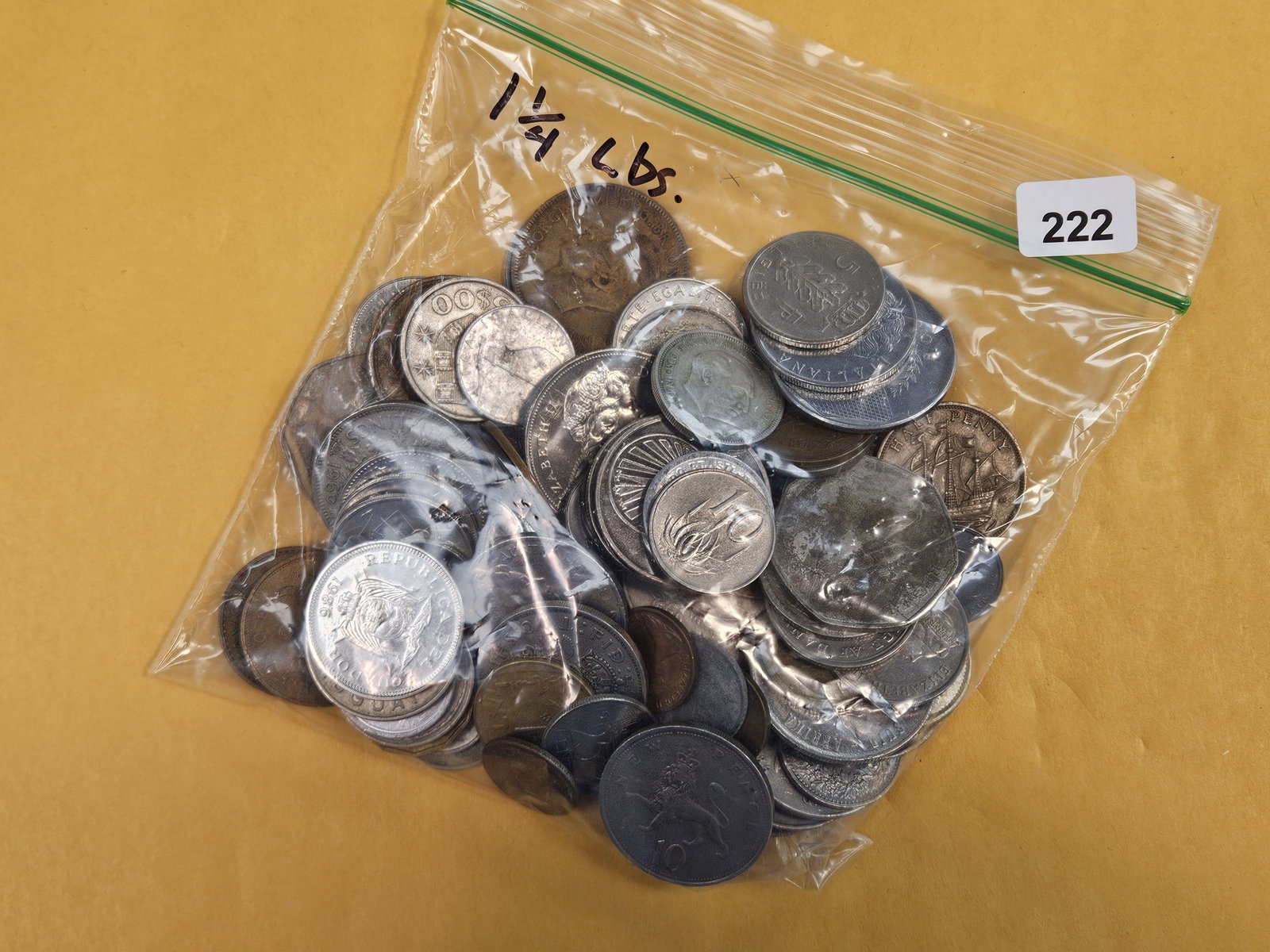 One and one-quarter pounds of mixed world coins: From dealer. Unchecked by us