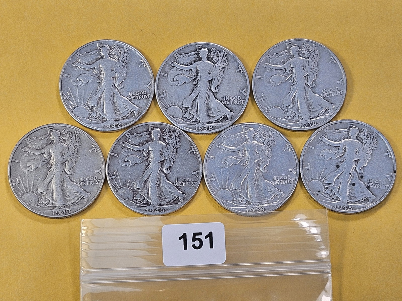 Seven Circulated Walking Liberty Silver Half Dollars: Mixed dates and grades