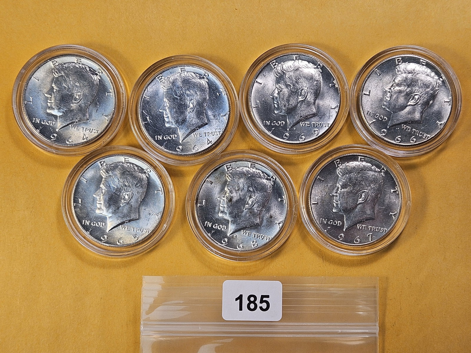 Seven Brilliant Uncirculated Kennedy Silver Half Dollars: Two 1964, 1965, 1966, 1967, 1968 and 1969
