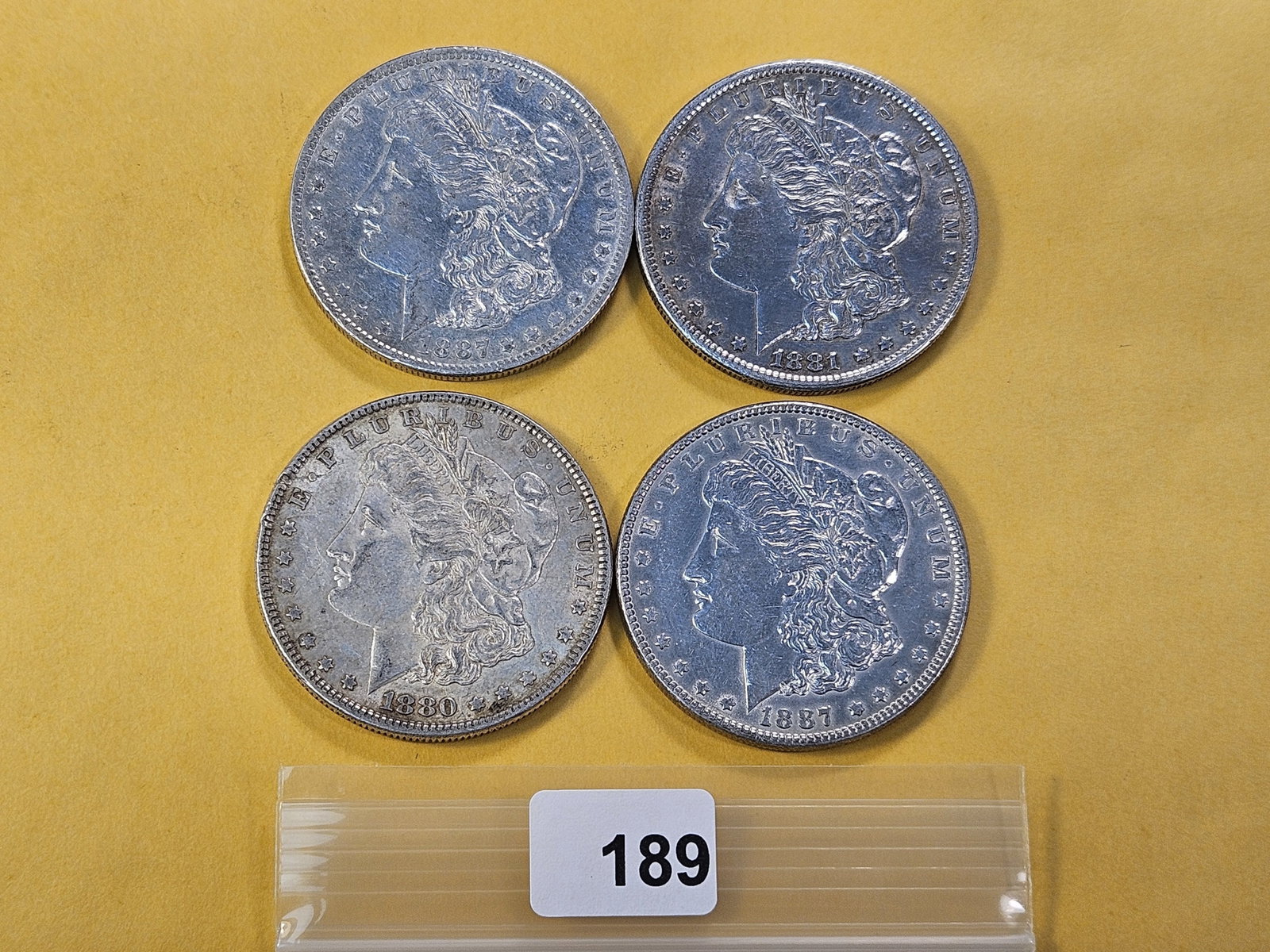 Four Circulated Morgan Silver Dollars: 1880-O, 1881-S, 1887 and 1887-O