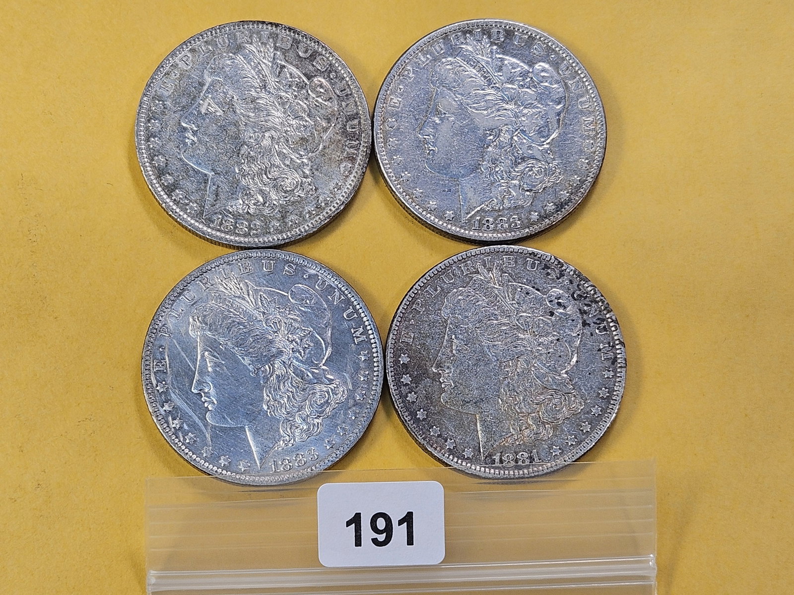 Four Circulated Morgan Silver Dollars: 1881-O, 1882-O, 1883-O and 1883