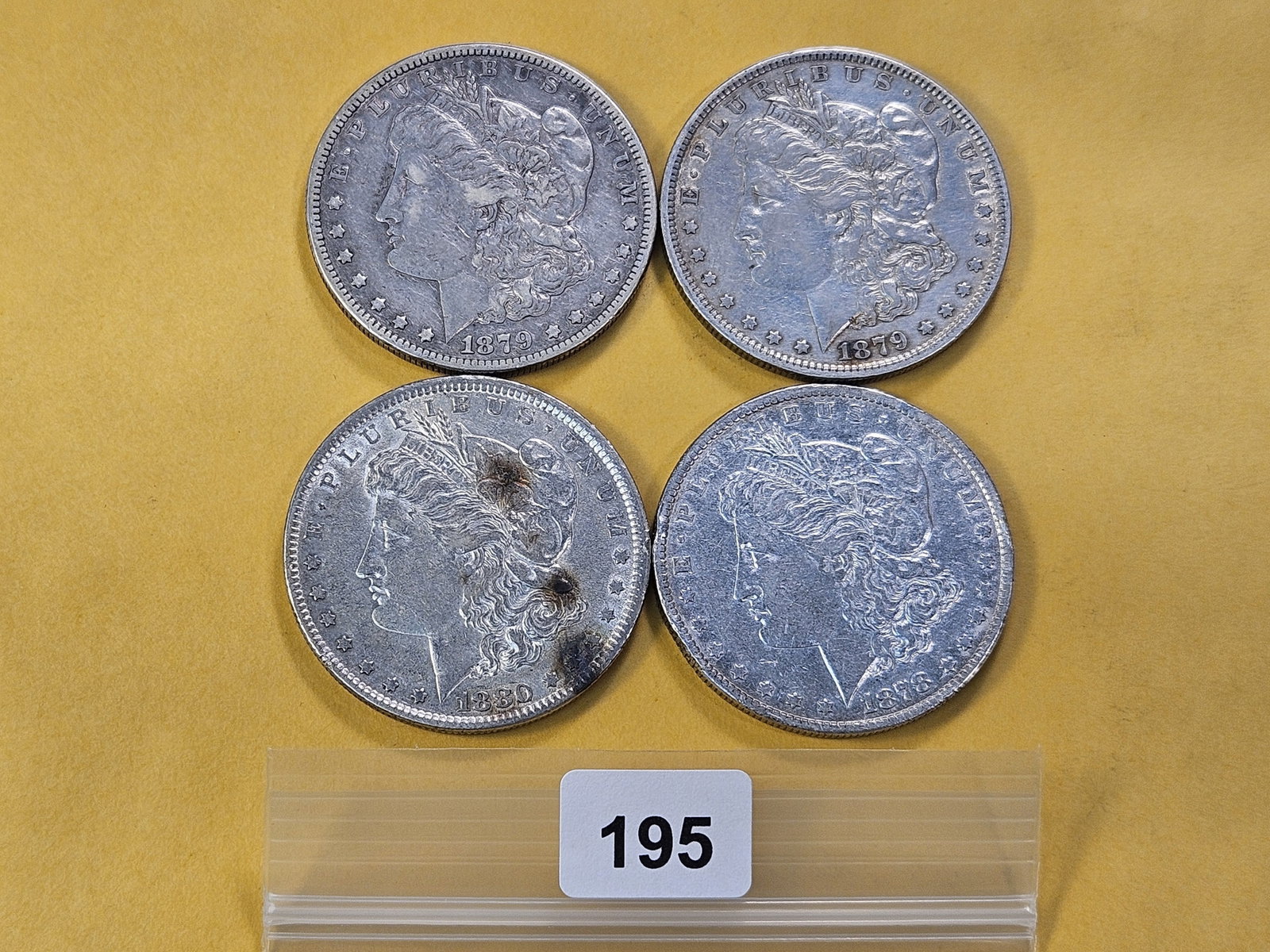 Four Circulated Morgan Silver Dollars: 1878, 1879, 1879-S and 1880
