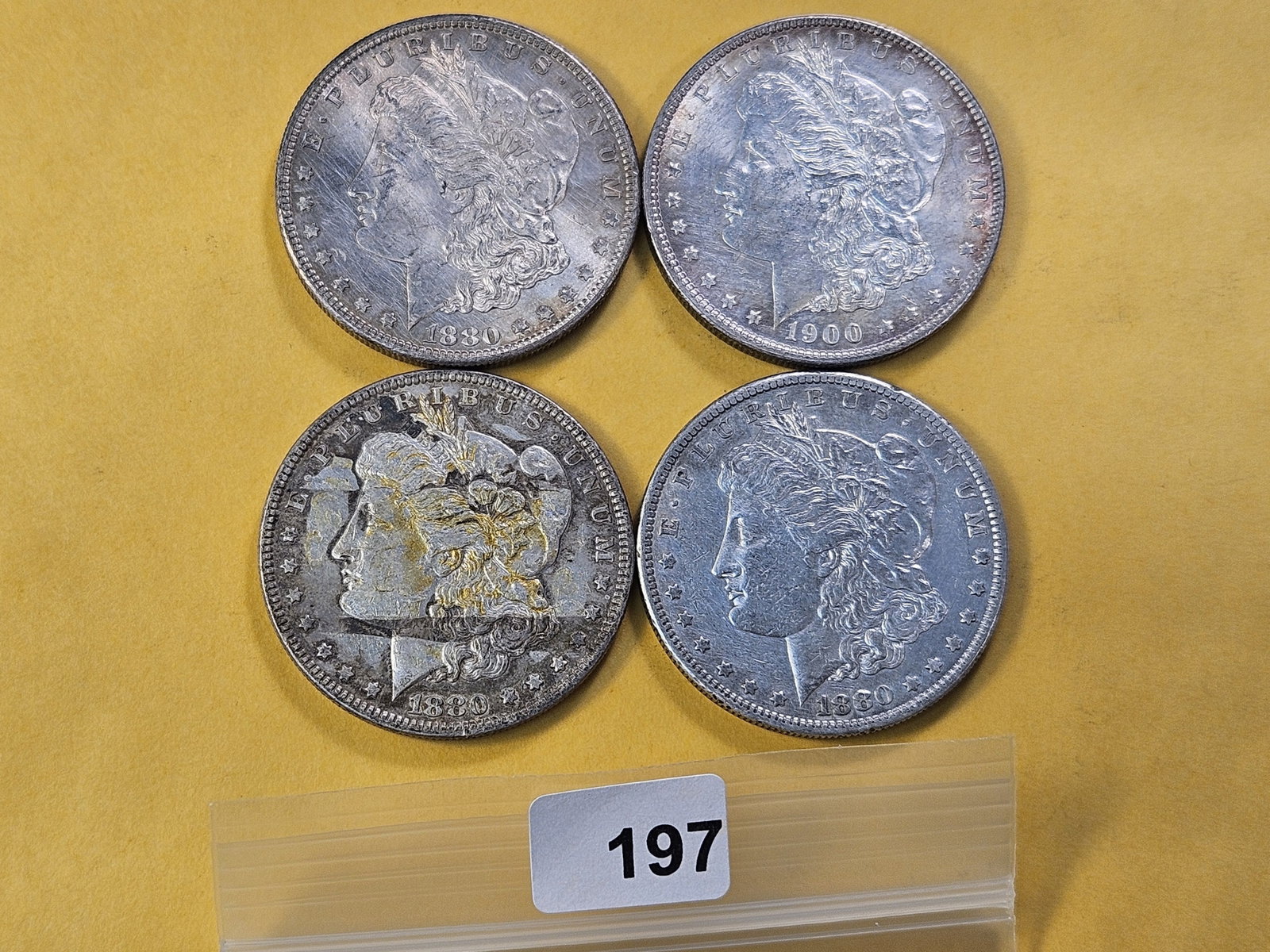 Four Circulated Morgan Silver Dollars: 1880, 1900 and two 1880