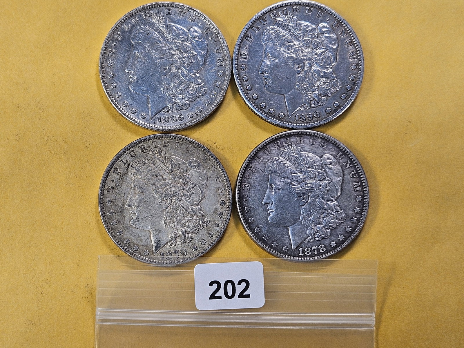Four Circulated Morgan Silver Dollars: 1878, 1879, 1885-O and 1890-S