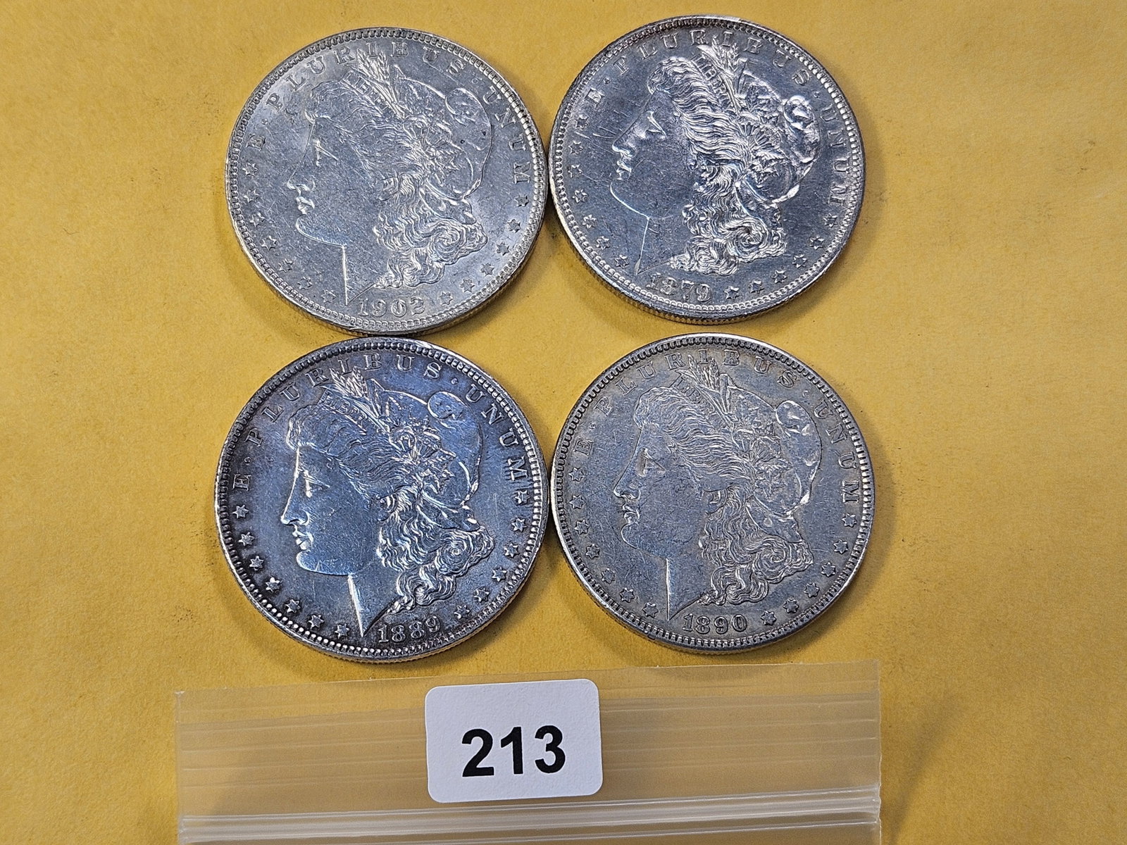 Four Lightly Circulated Morgan Silver Dollars: 1879-S, 1889, 1890 and 1902
