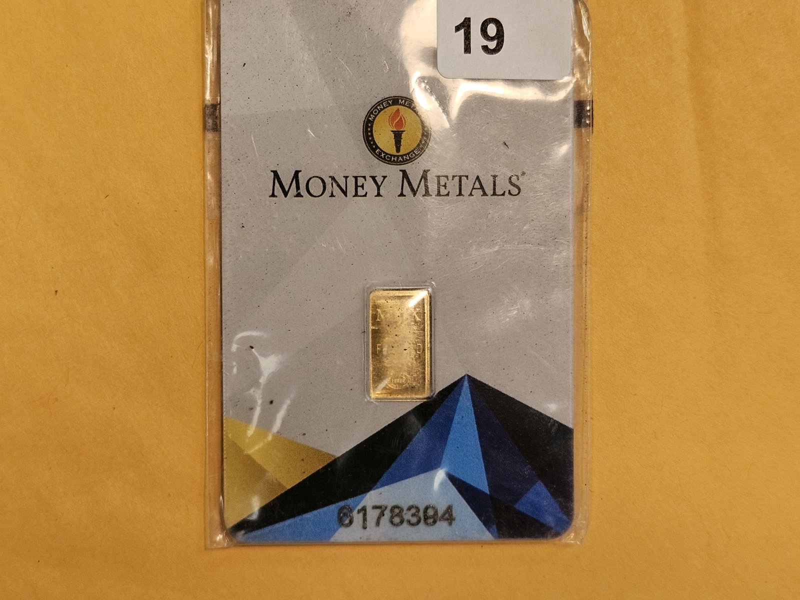 GOLD! Money Metals One-Half Gram .9999 fine gold bar: In original assay holder. Packaging is a little scuffy