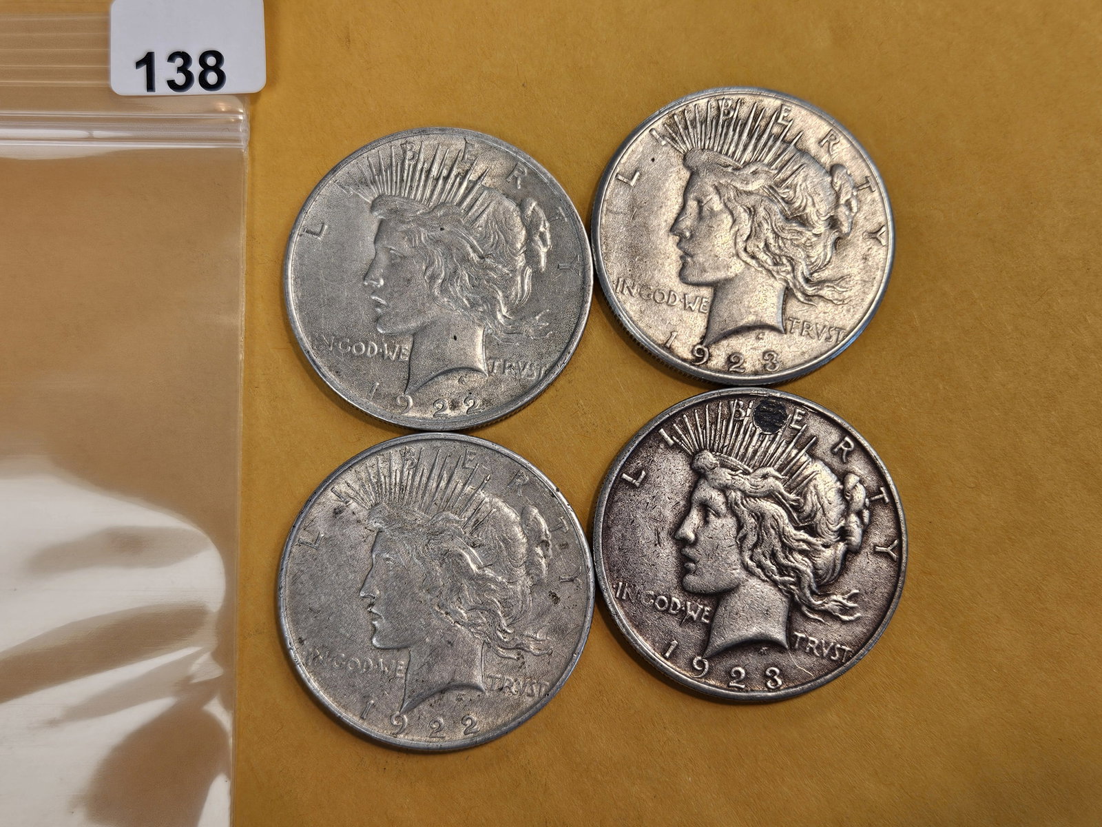 Four mixed Peace Silver Dollars: Circulated