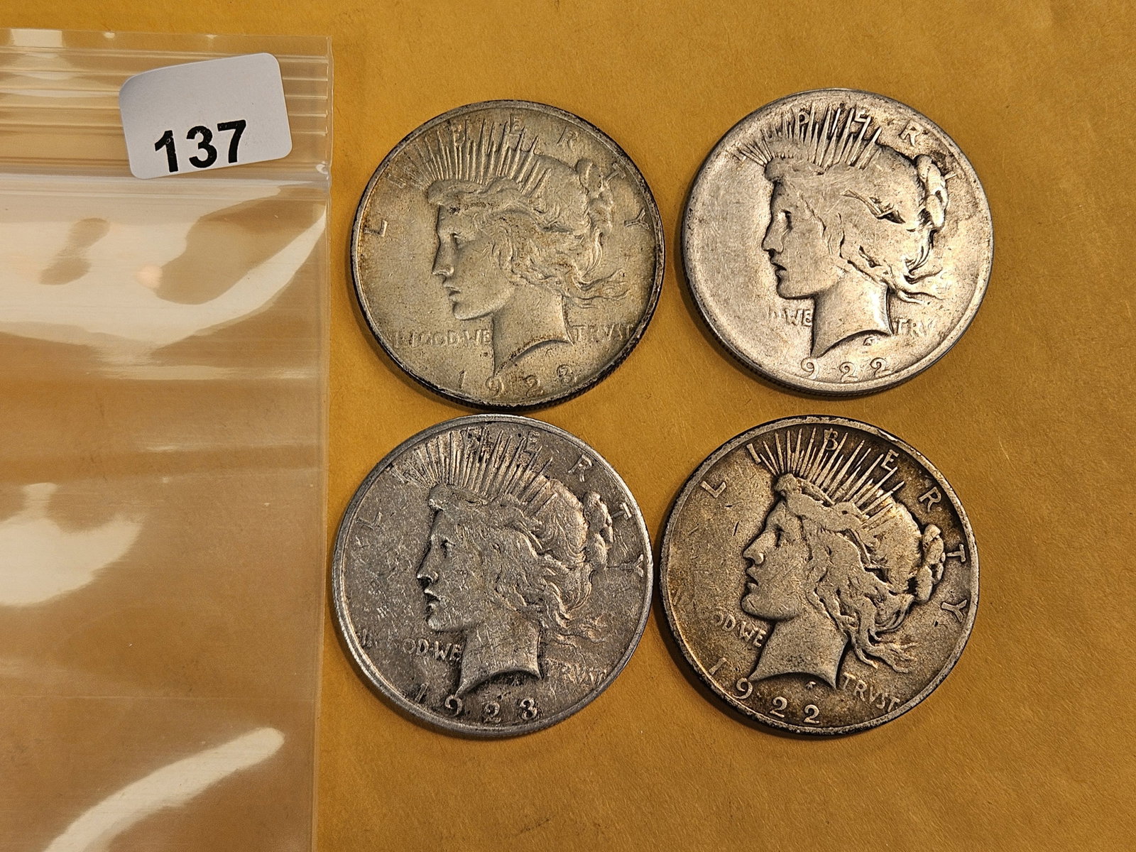 Four mixed Peace Silver Dollars: Circulated