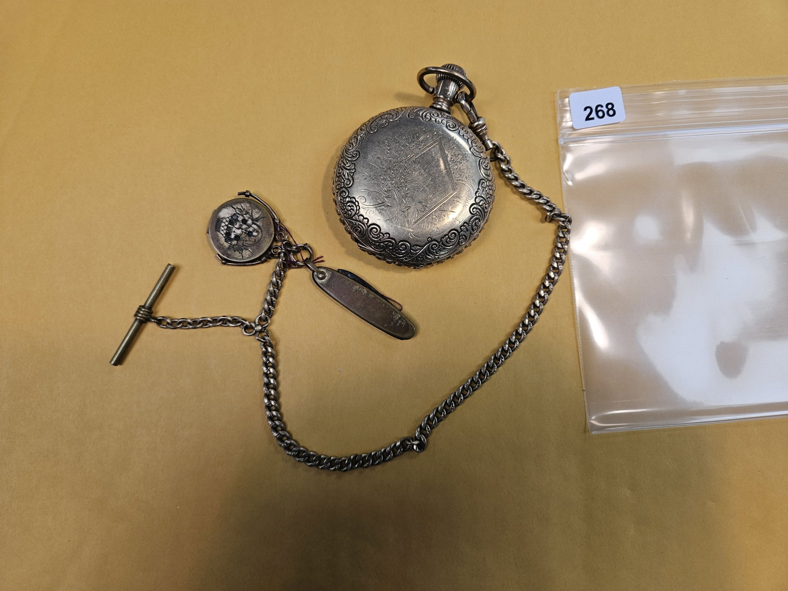 Gold-Filled Elgin Pocketwatch: Very nice piece. The watch, chain, and from what the consignor said the knife and other little piece are all gold-filled. Three layers of gold-fill. Movement still moved inside. Not sure about anythin