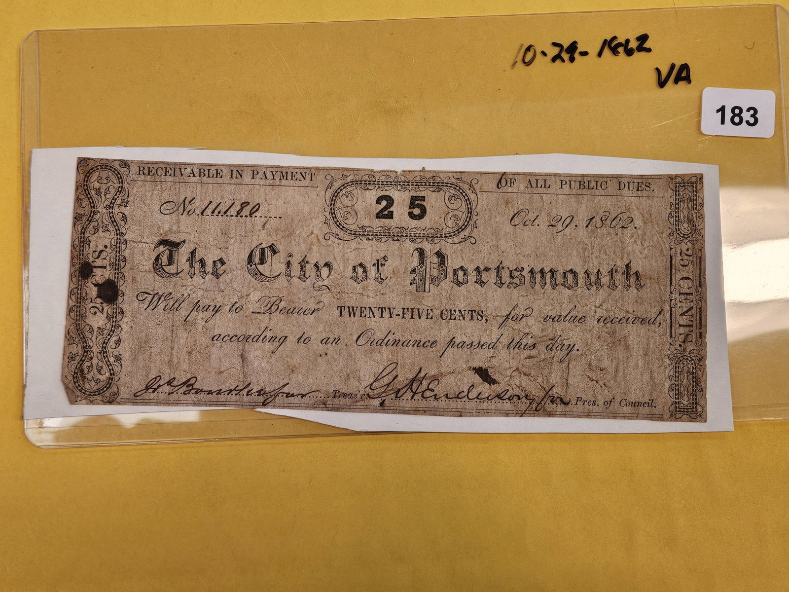1862 City of Portsmouth Twenty-five Cent note: VIrginia. It is lightly attached to the cardboard
