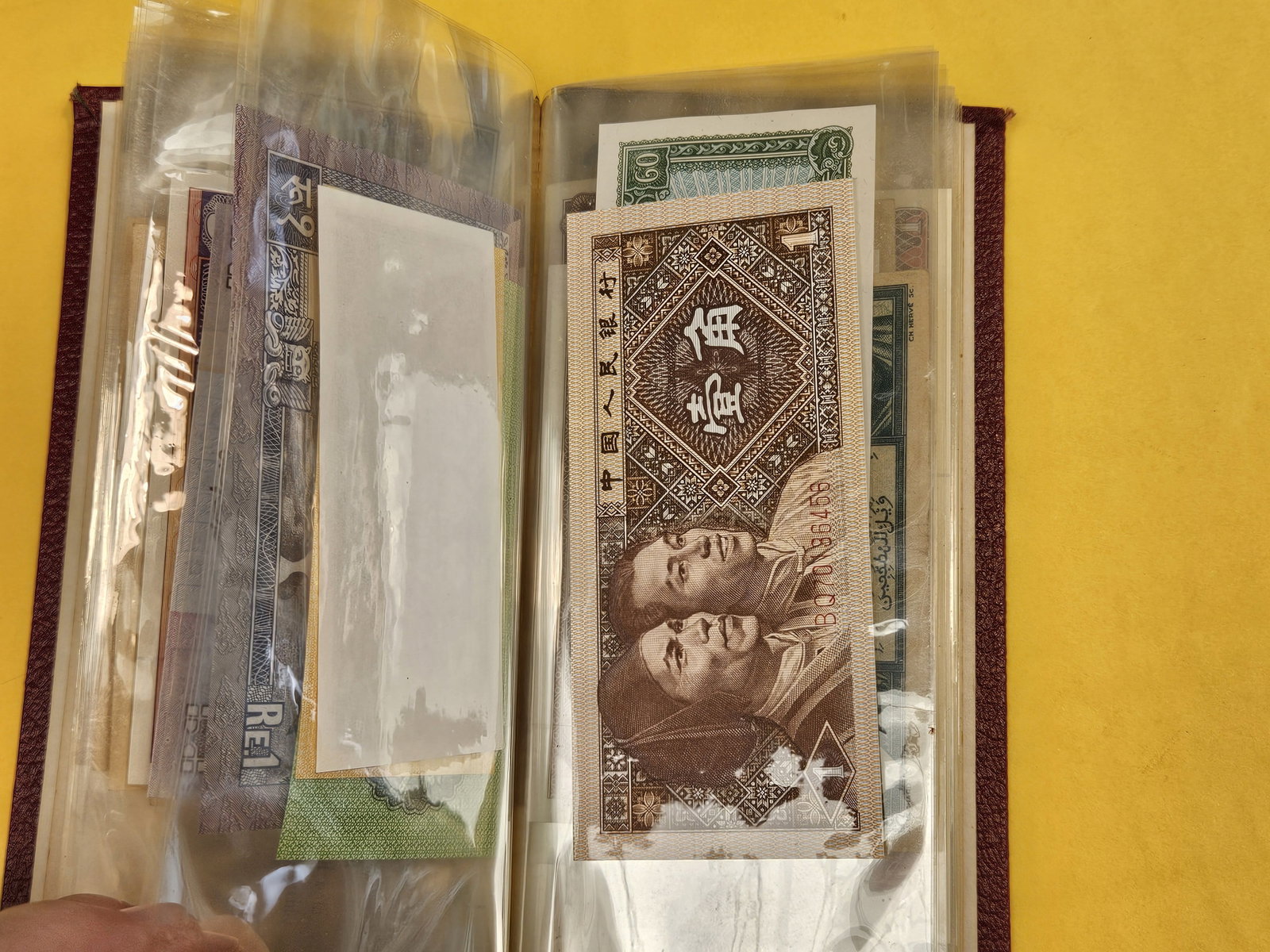 Hardcover booklet with about 40 or so pieces of World Currency - 10