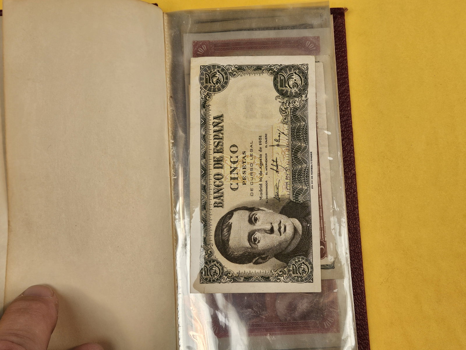 Hardcover booklet with about 40 or so pieces of World Currency - 2
