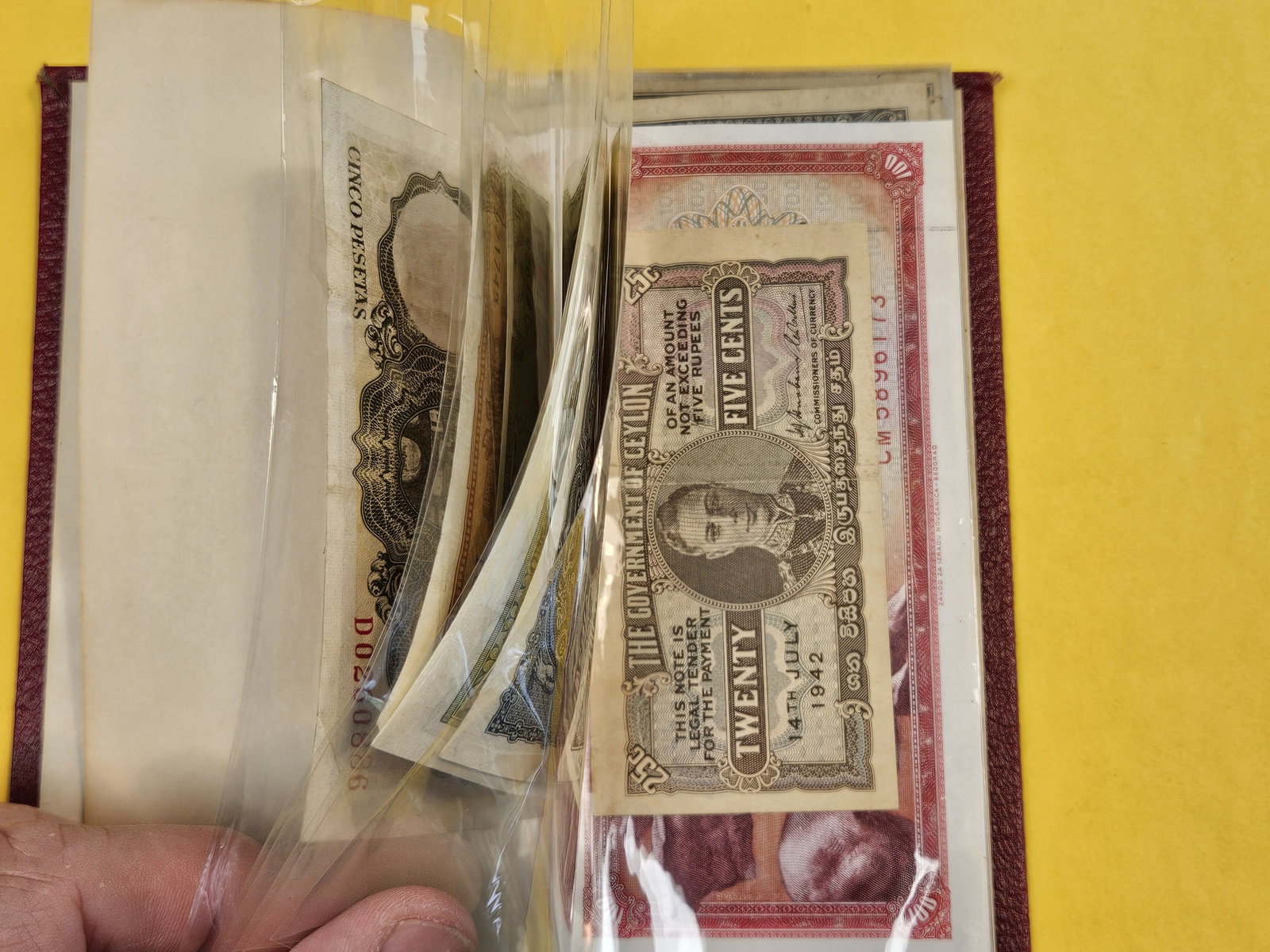 Hardcover booklet with about 40 or so pieces of World Currency - 3